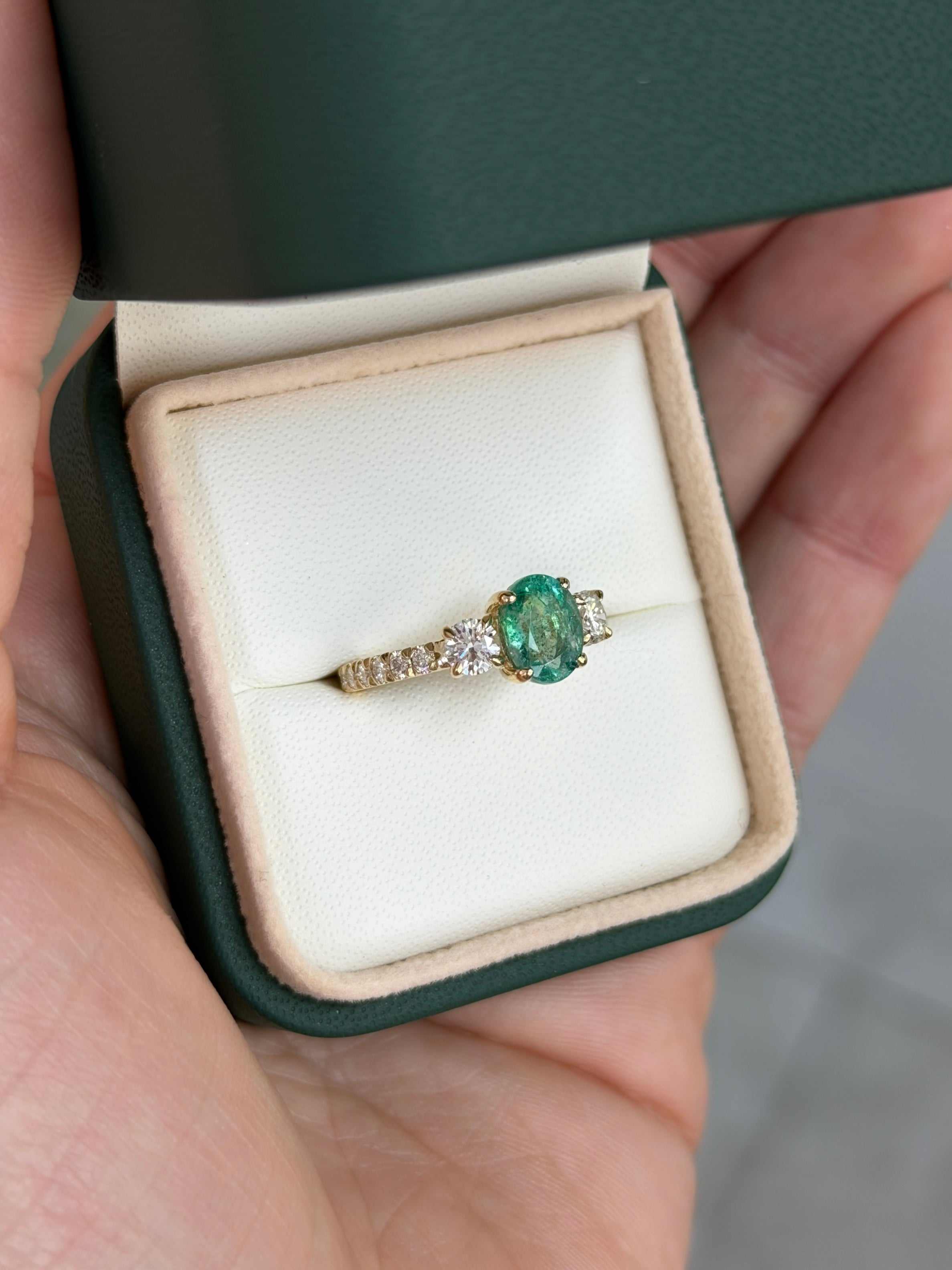 Oval emerald and round lab diamond three-stone ring with accents in 14K gold, featuring JR Colombian Emeralds branding.