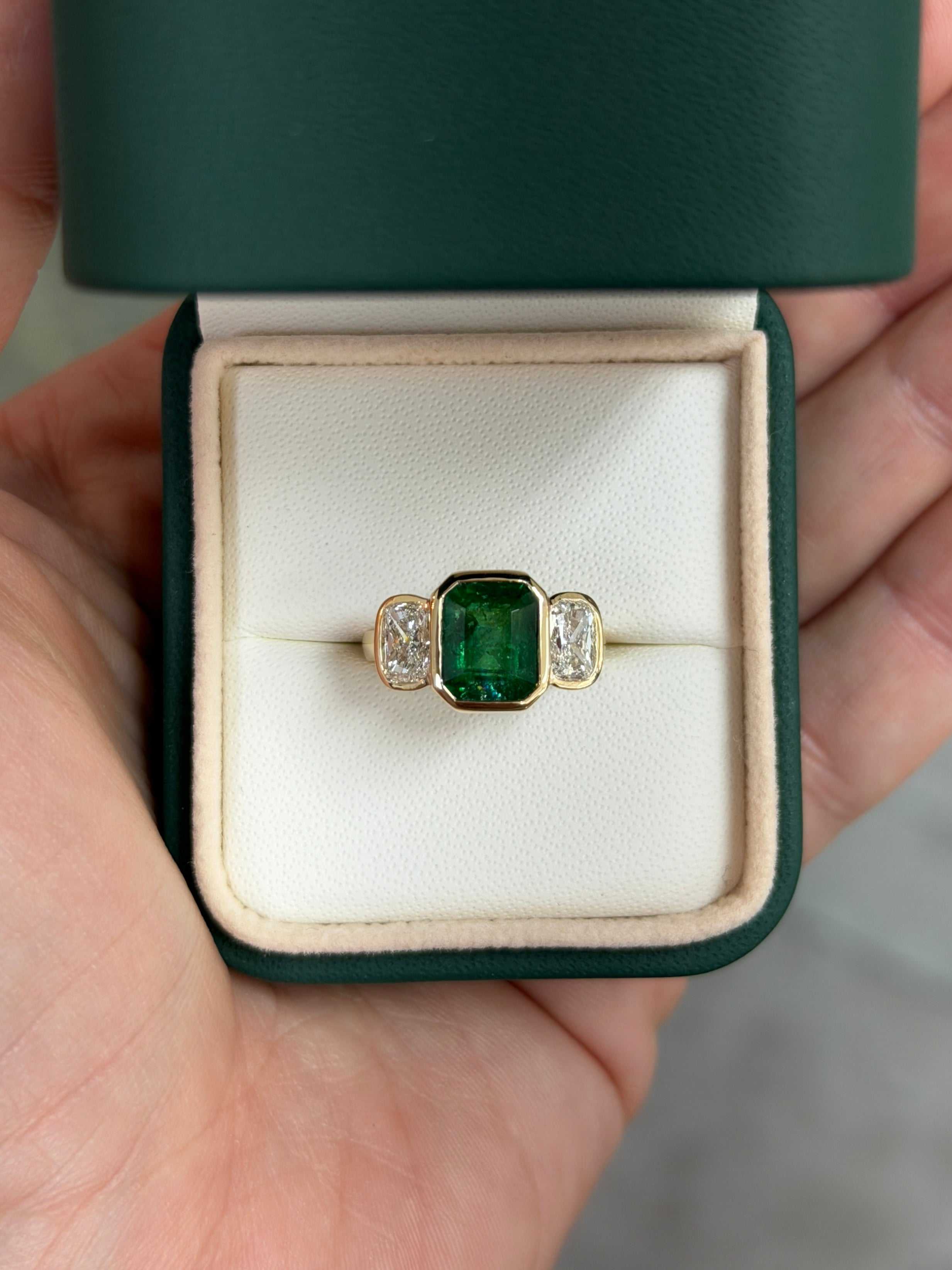 Three-stone lab diamond ring with bezel-set emerald and cushion cut diamonds, 14K gold, from JR Colombian Emeralds.