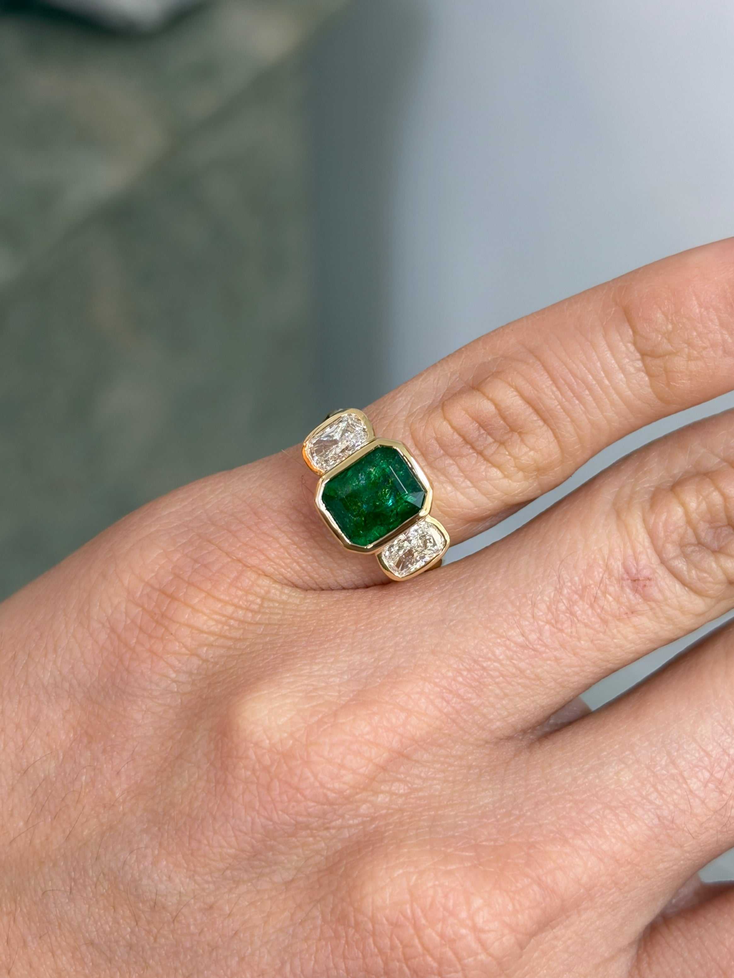 Three-stone ring featuring bezel-set emerald and cushion-cut lab diamond, 14K gold, 3.70 tcw from JR Colombian Emeralds.