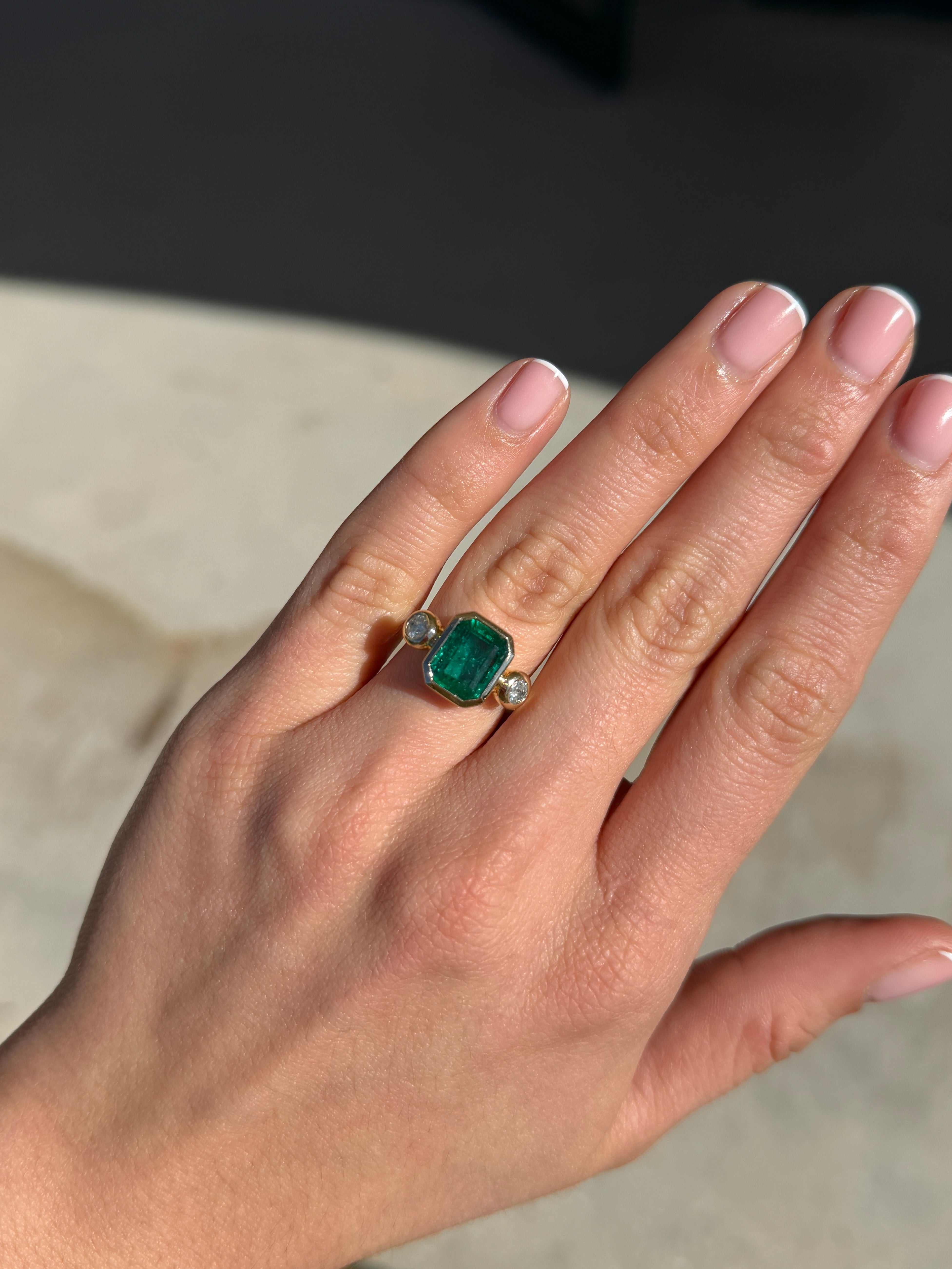 Natural dark emerald and round diamond three-stone ring with 18K gold by JR Colombian Emeralds, featuring a stunning gemstone centerpiece.
