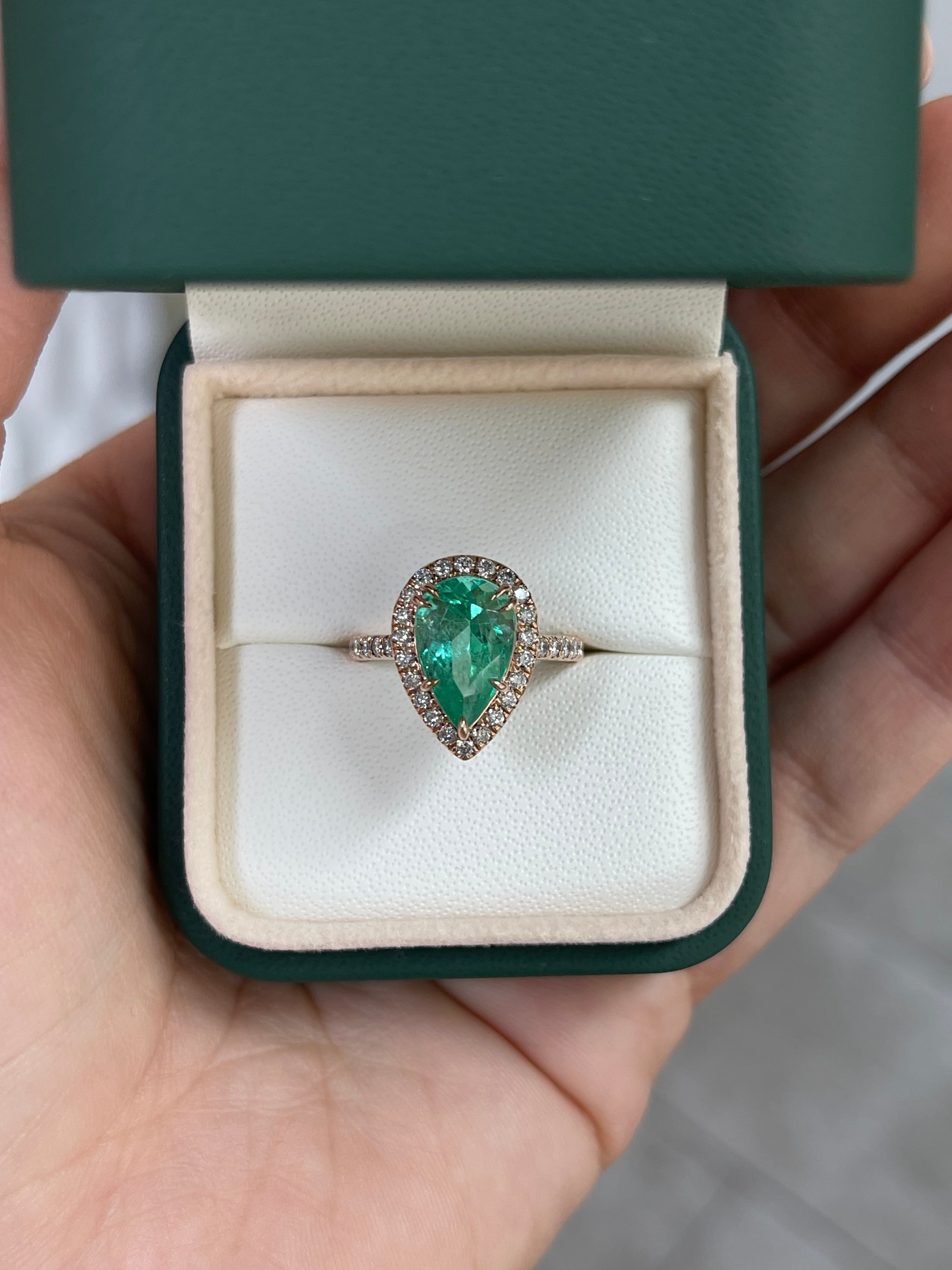 14K rose gold engagement ring with a 3.44ct pear-shaped emerald center stone, diamond halo, and shank from JR Colombian Emeralds.