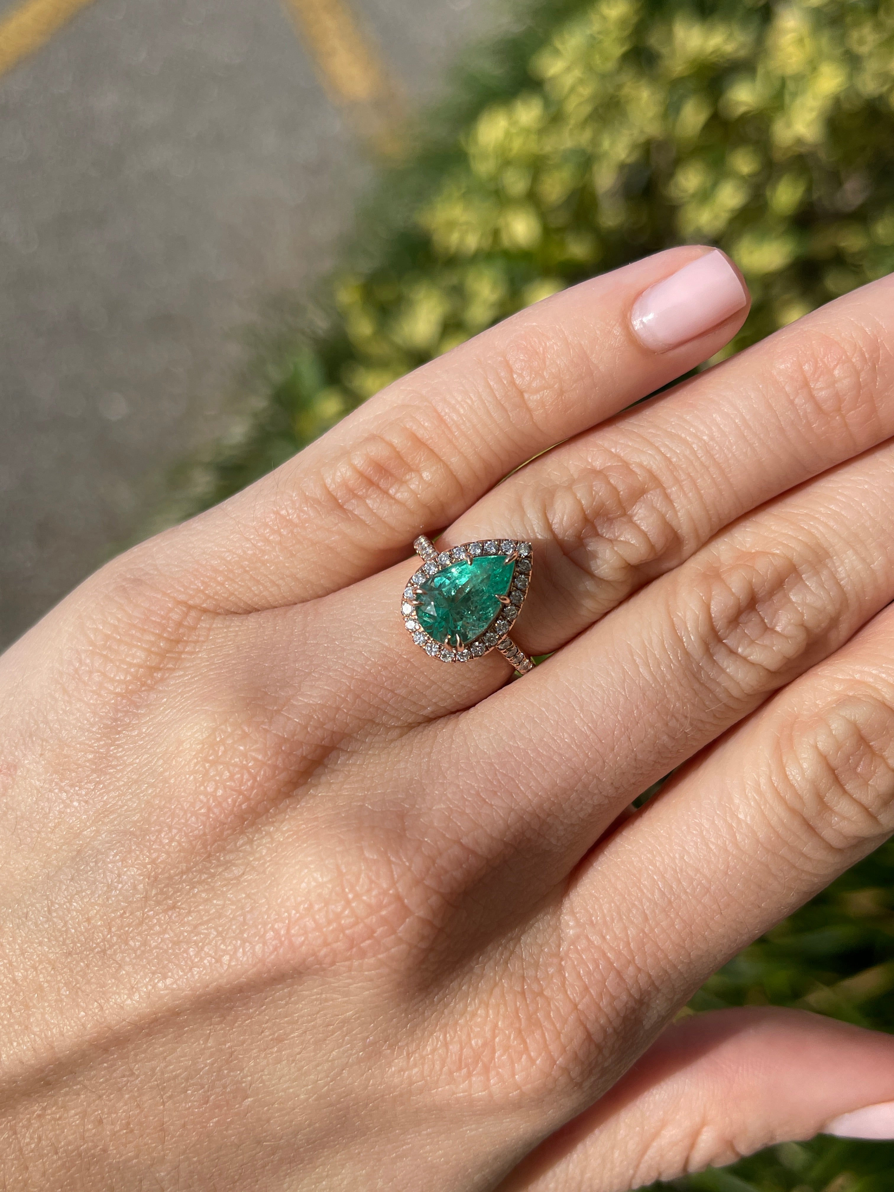 14K rose gold engagement ring with 3.44tcw pear emerald and diamond halo, featuring a detailed shank design by JR Colombian Emeralds.