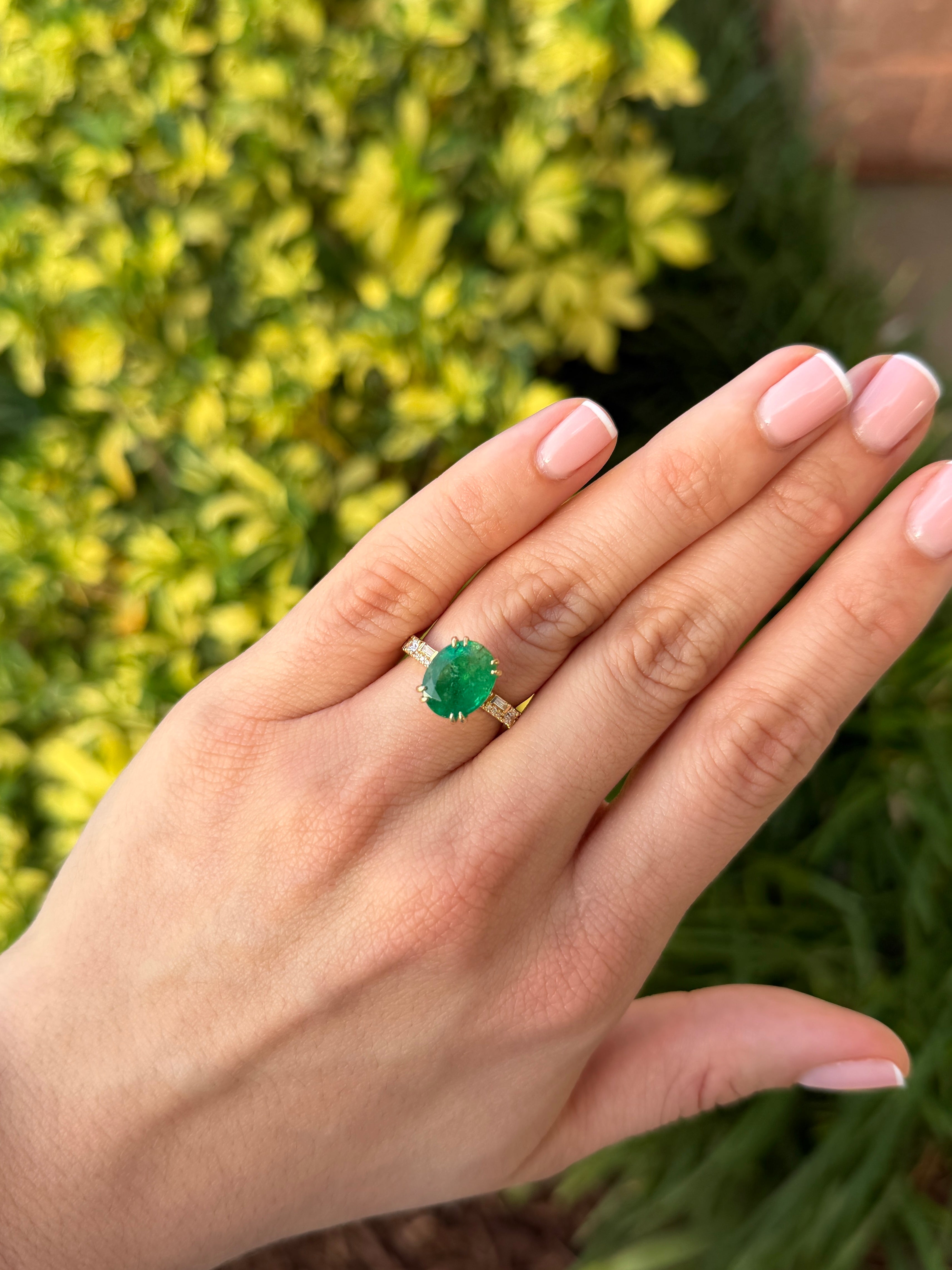 Natural oval emerald and lab diamond accented band in 14K gold by JR Colombian Emeralds, featuring elegant gemstone details.