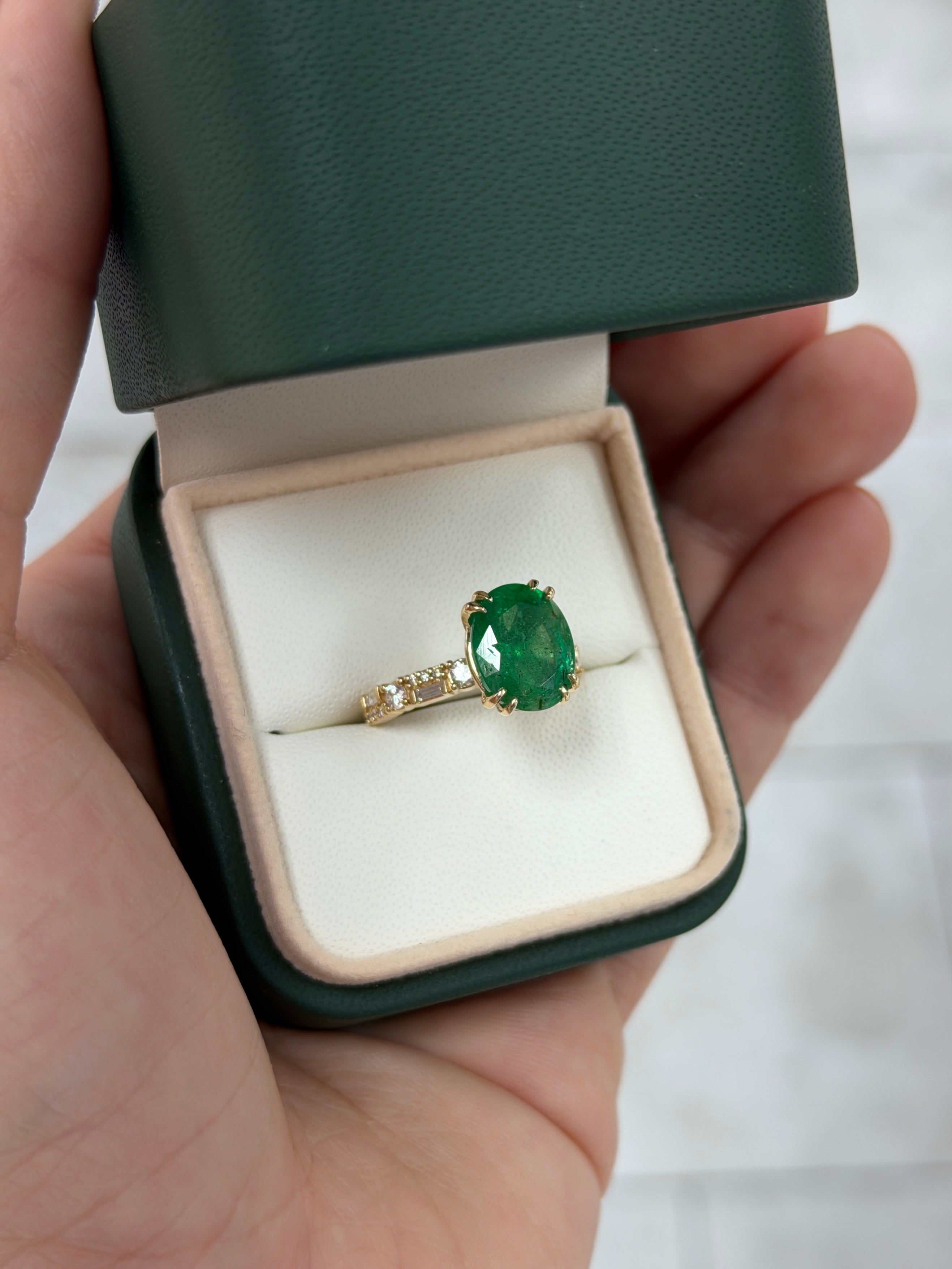 Oval emerald and lab diamond accented band in 14K gold by JR Colombian Emeralds, featuring natural green emeralds and sparkling diamonds.