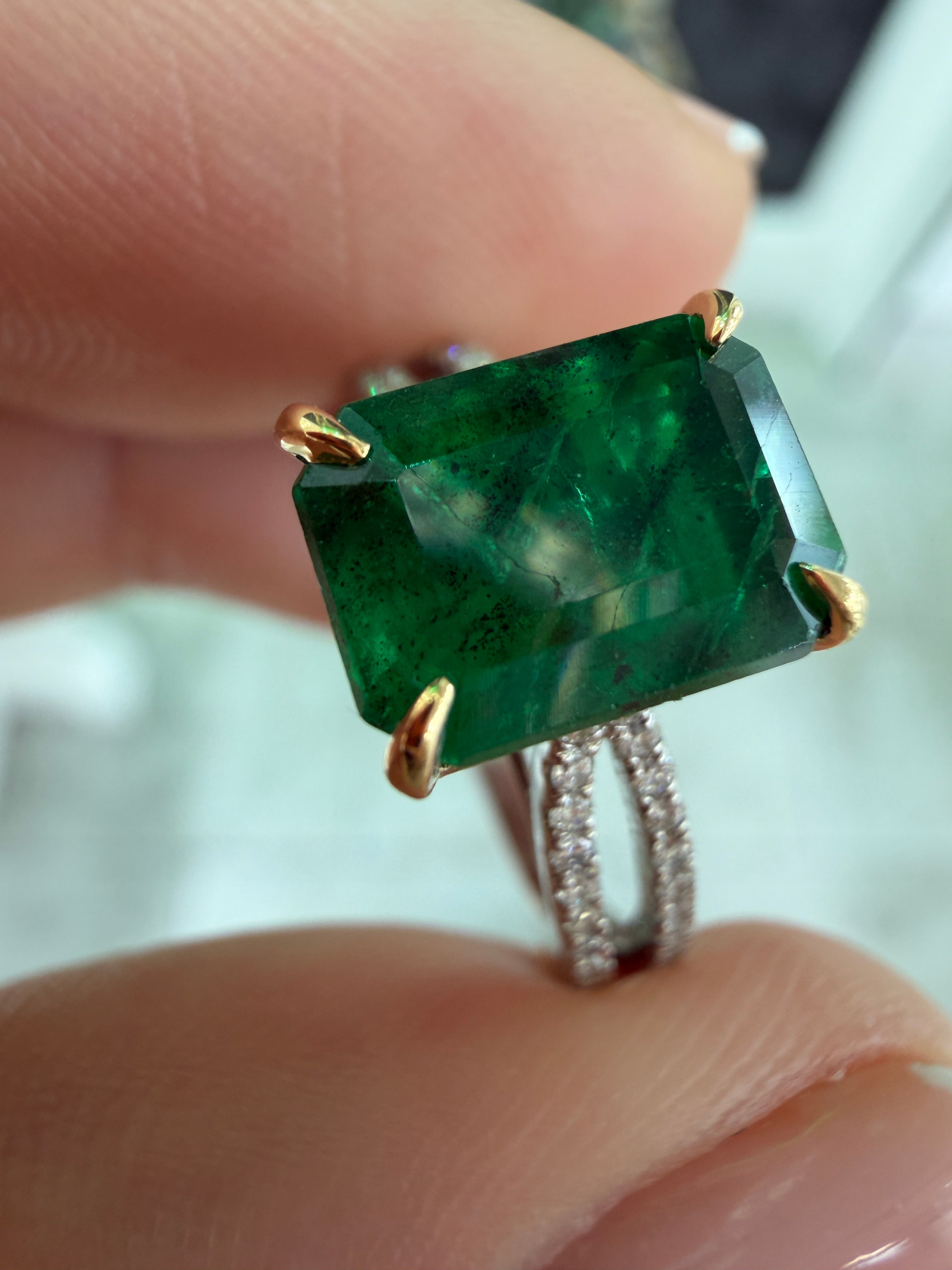 18K/PLAT green emerald and diamond split shank engagement ring with 2.75tcw from JR Colombian Emeralds, showcasing intricate design and gemstones.