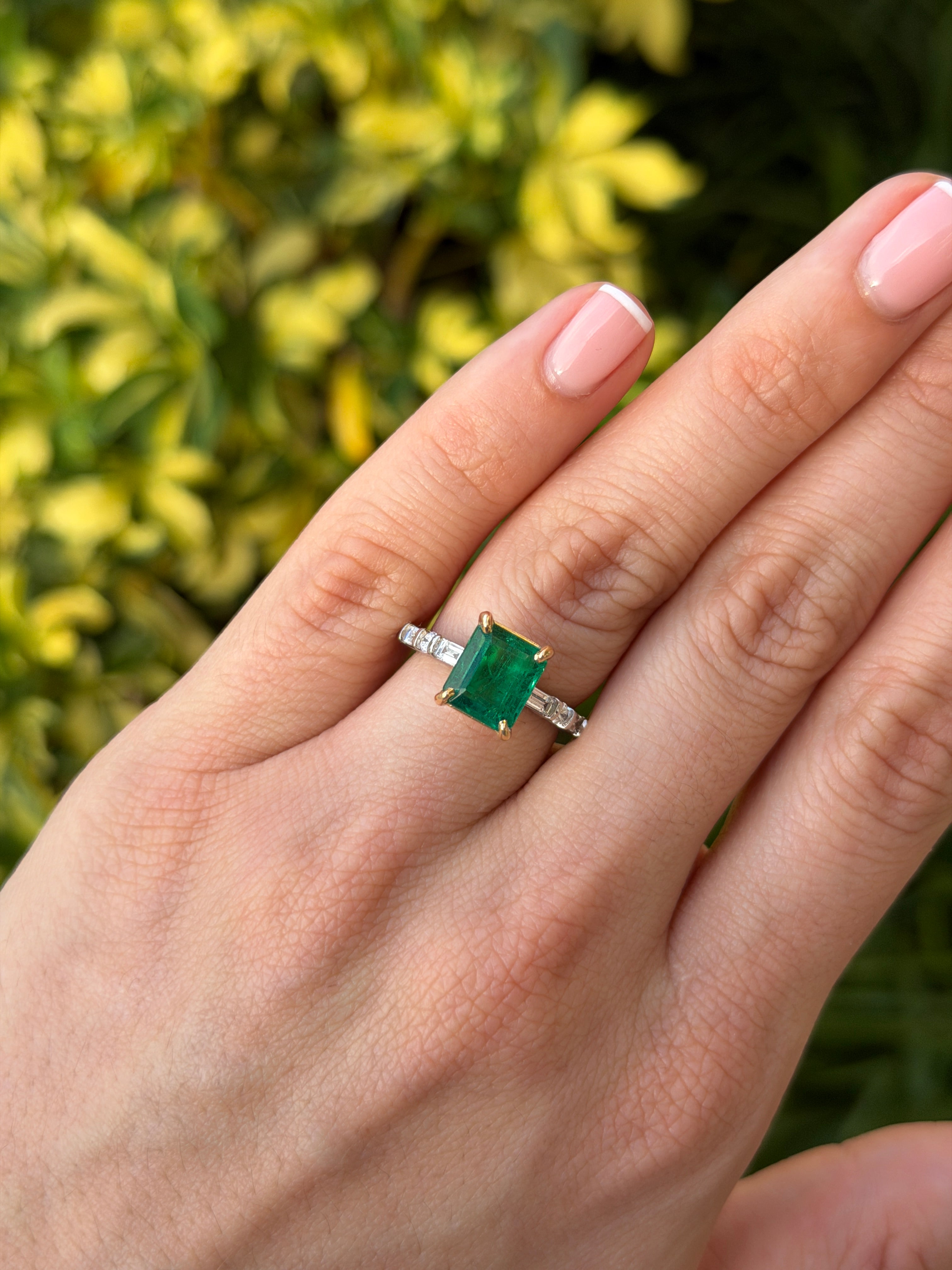 18K gold engagement ring with 3.55tcw vivid natural emerald and platinum diamond baguette accents, elegant and luxurious design