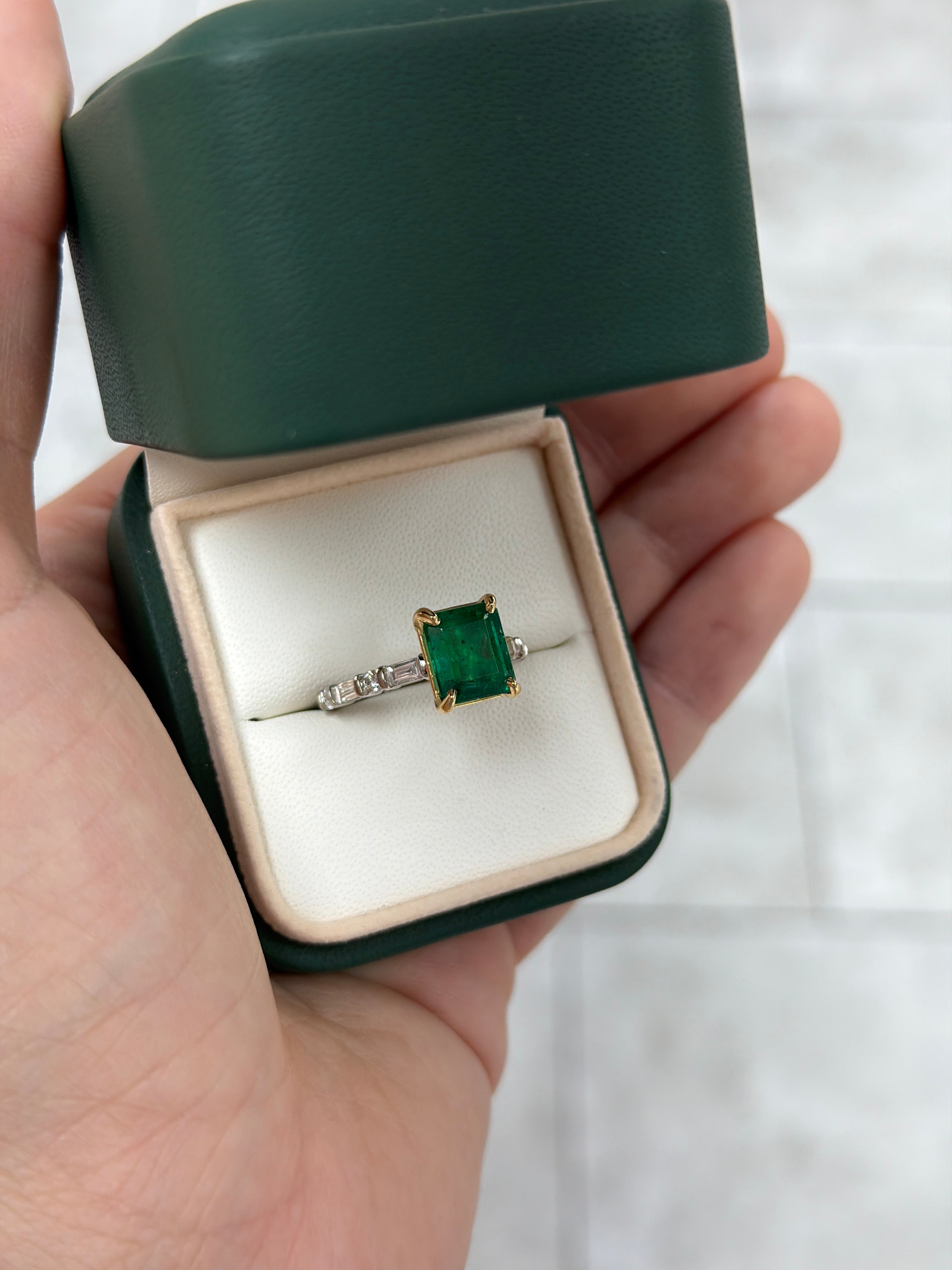 18K gold engagement ring with vivid natural emerald and platinum diamond baguette accents, designed by JR Colombian Emeralds.