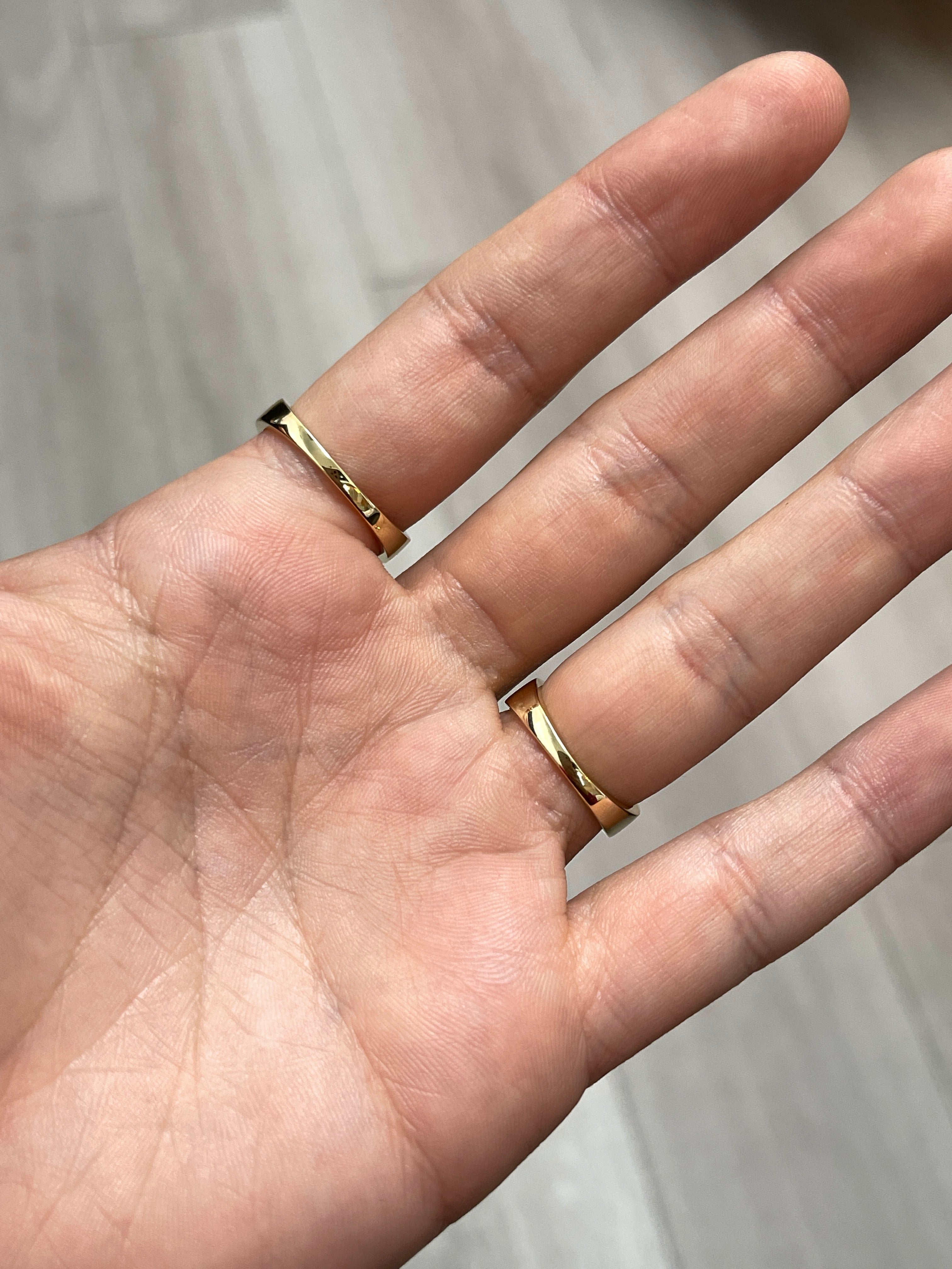 Three-row square emerald and diamond wedding band in 14K gold, featuring vibrant green emeralds and sparkling diamonds.