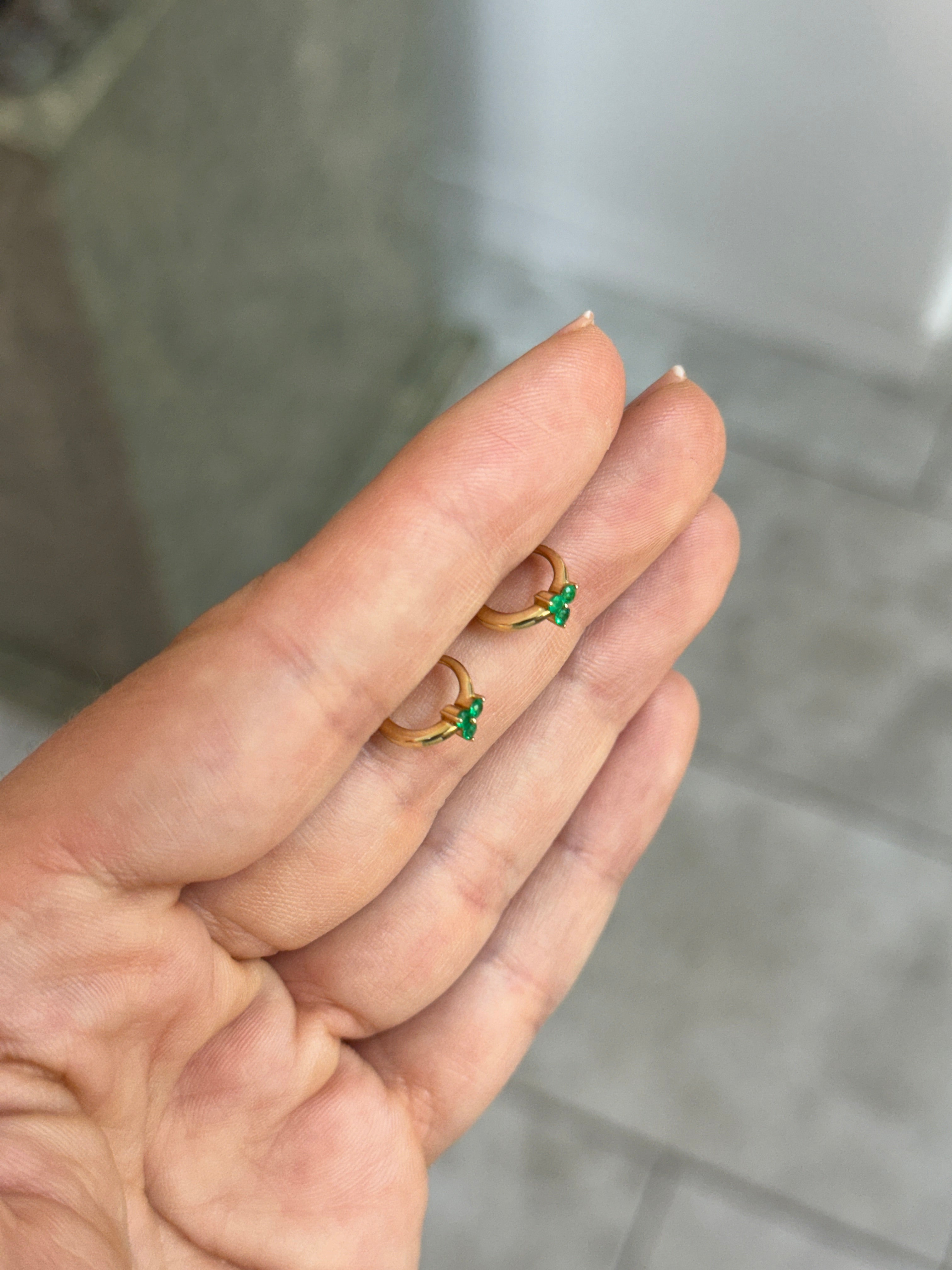 JR Colombian Emeralds 0.22tcw emerald trio huggie earrings in 14K gold with three vibrant green emeralds and a secure hoop design.