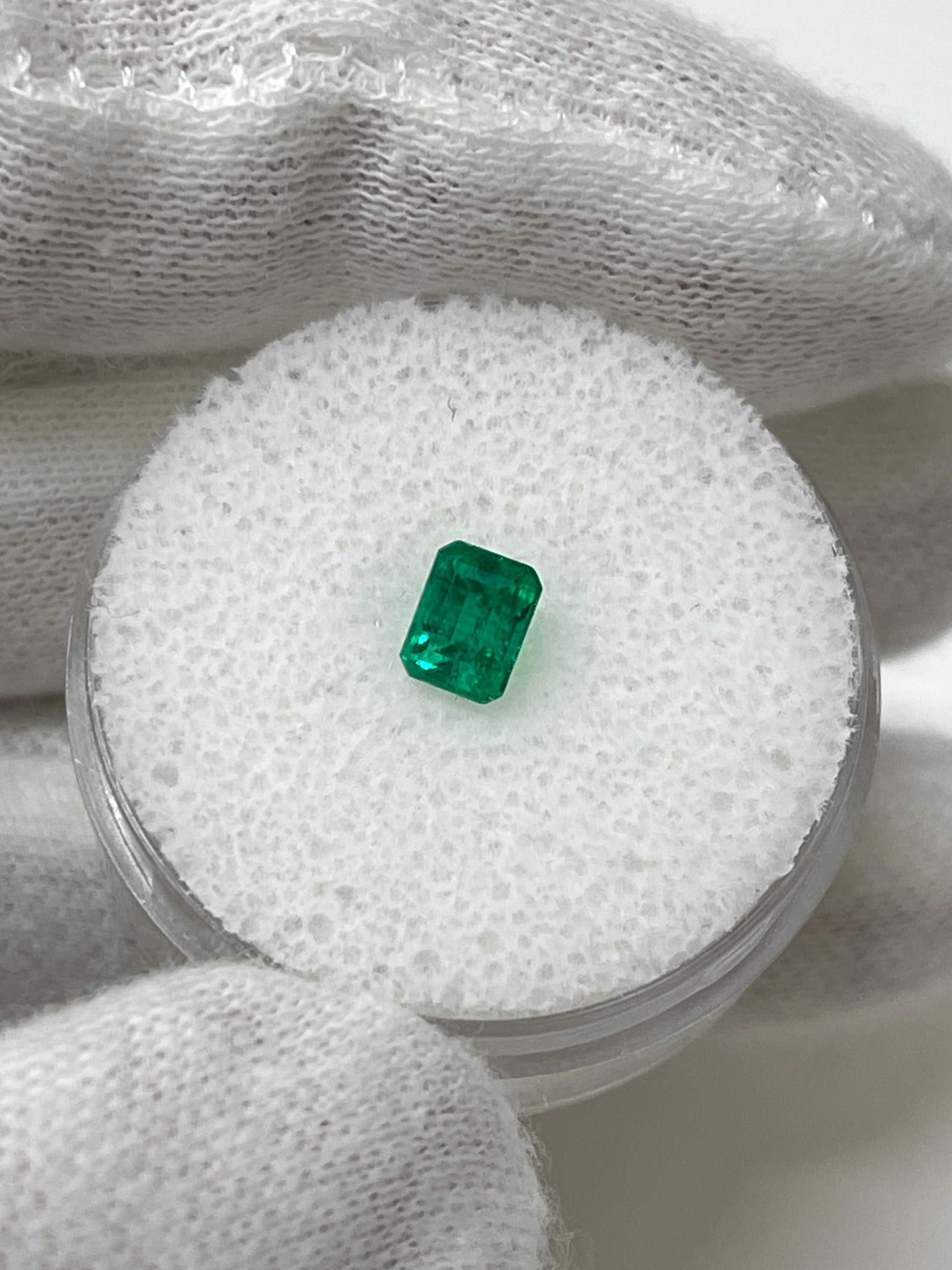 Loose 0.62 carat Colombian emerald cut gemstone with AAA+ quality from JR Colombian Emeralds. Bright green and faceted.