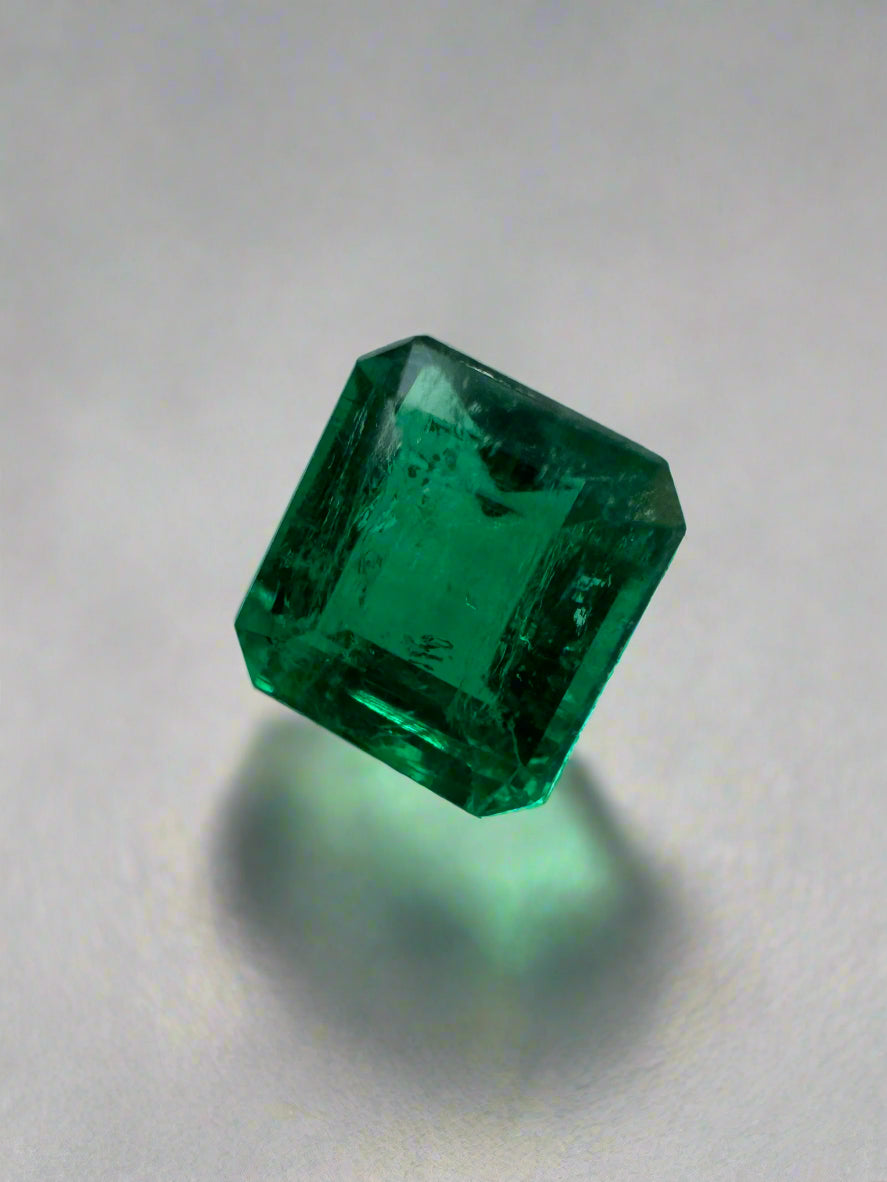 Loose 0.90 carat Colombian emerald in AAA+ quality, Asscher cut, with vibrant green color and clarity.
