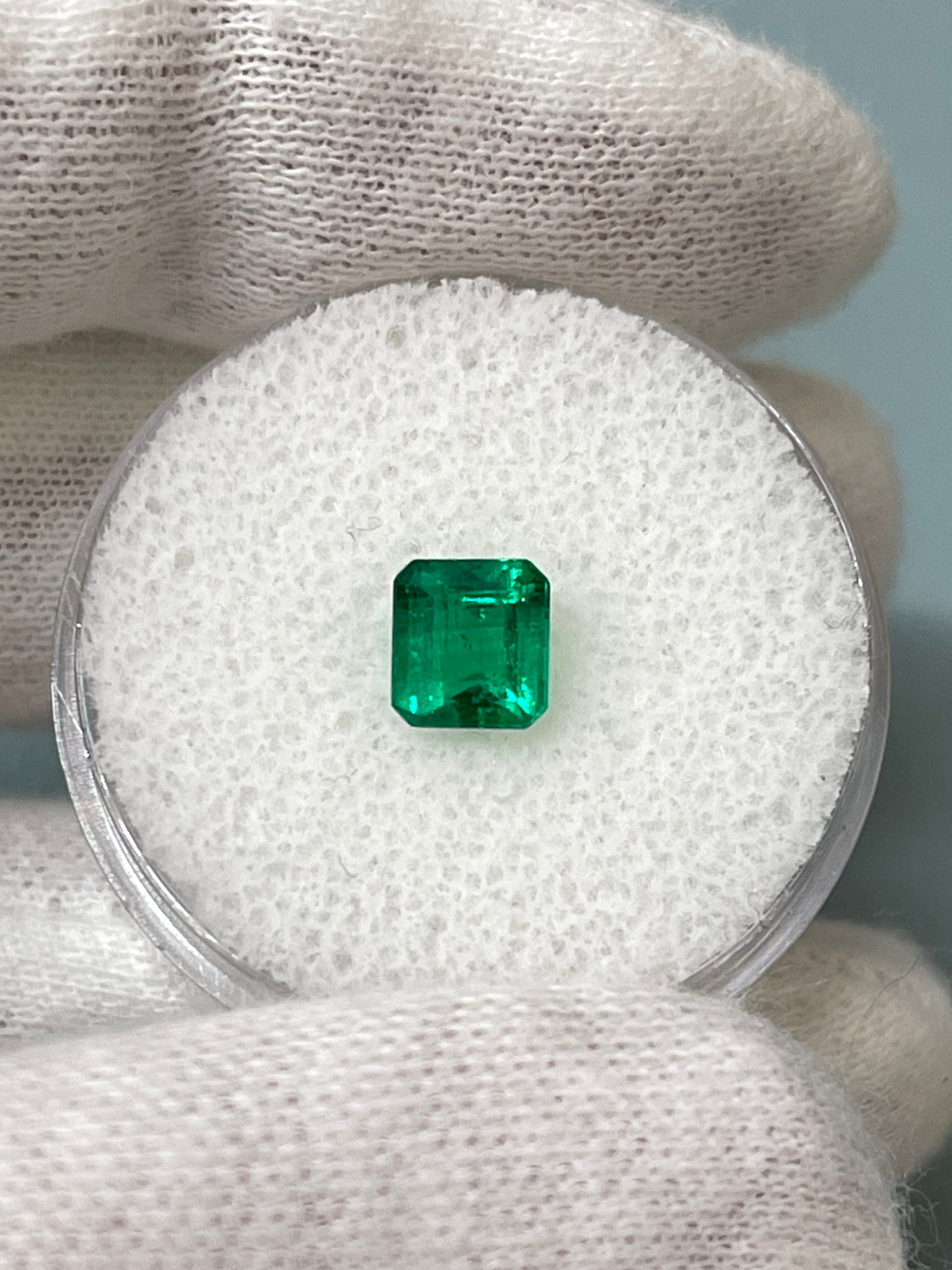 0.90 Carat AAA+ Colombian Emerald Asscher Cut loose gemstone with vibrant green color and fine clarity.