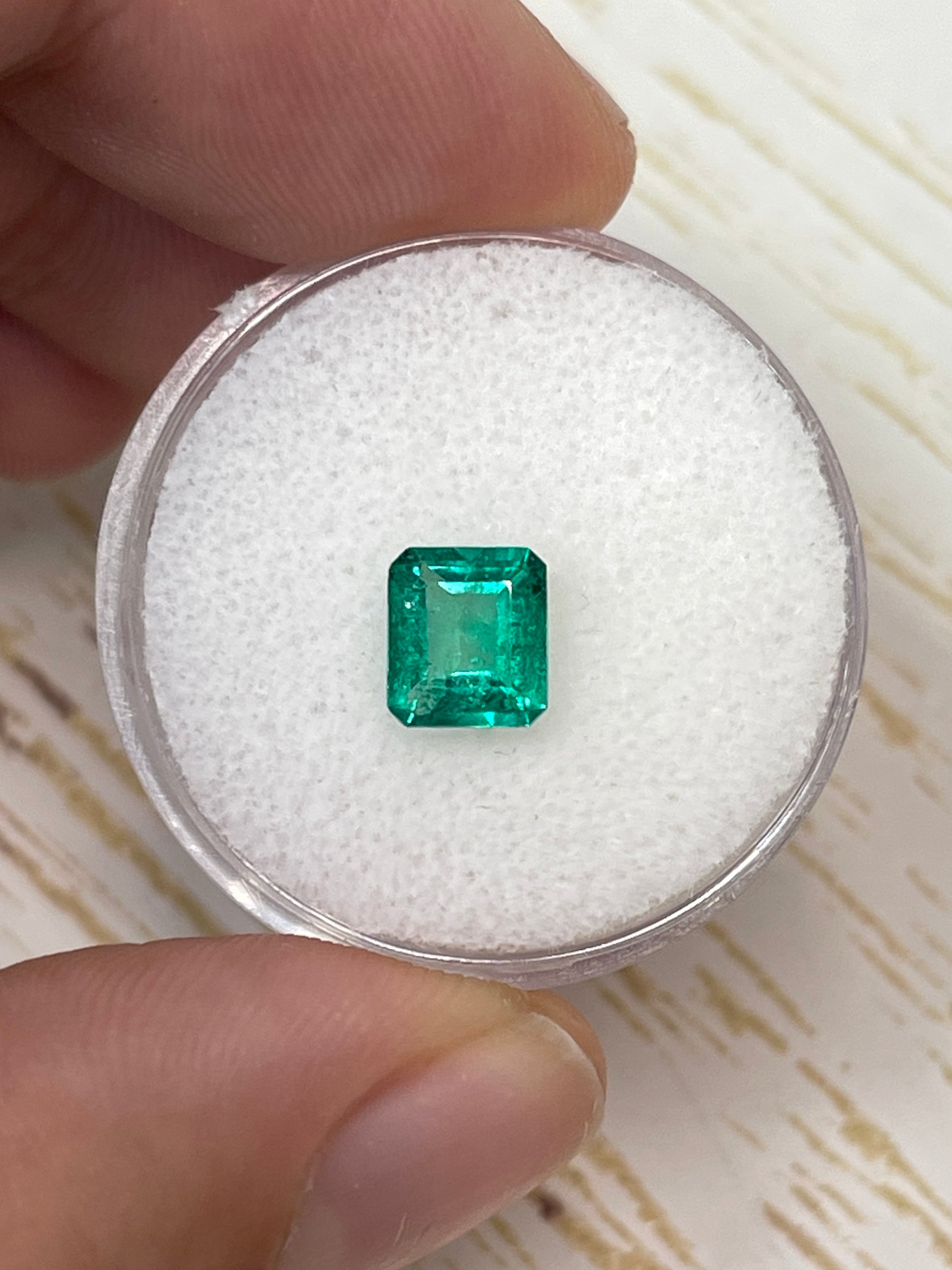 Vivid green 0.90 carat natural Colombian emerald in an emerald cut, showcasing clarity and rich color from JR Colombian Emeralds.