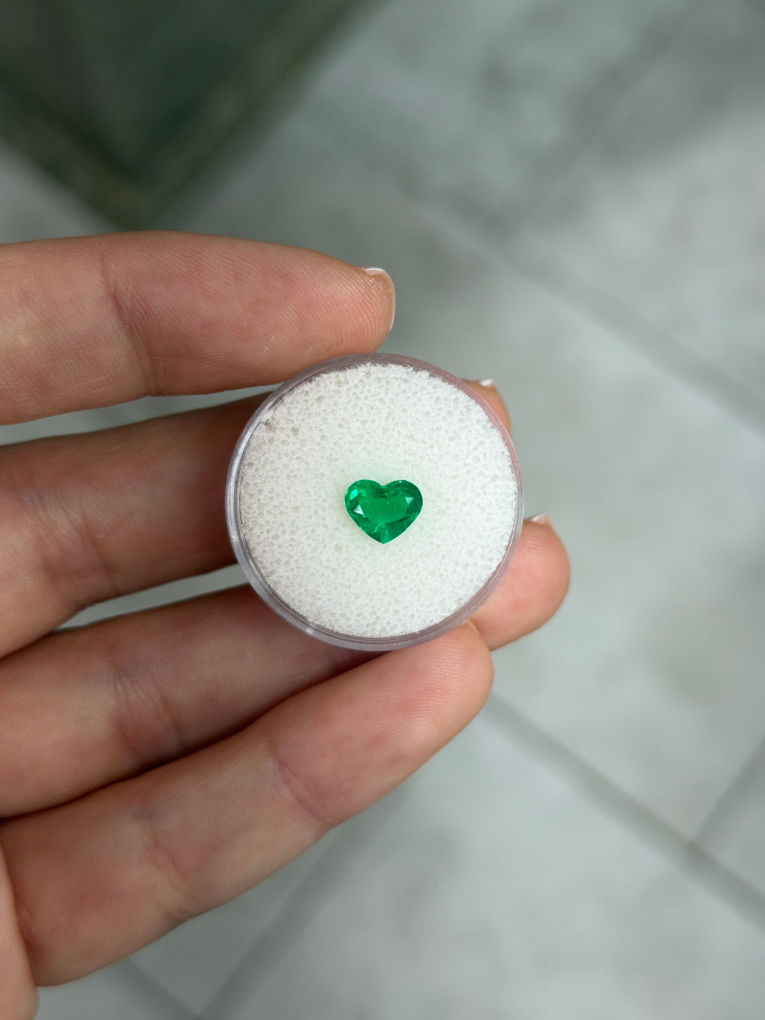 Vivid 0.95 carat Muzo green Colombian emerald loose gemstone with heart cut, AAA+ clarity, from JR Colombian Emeralds.