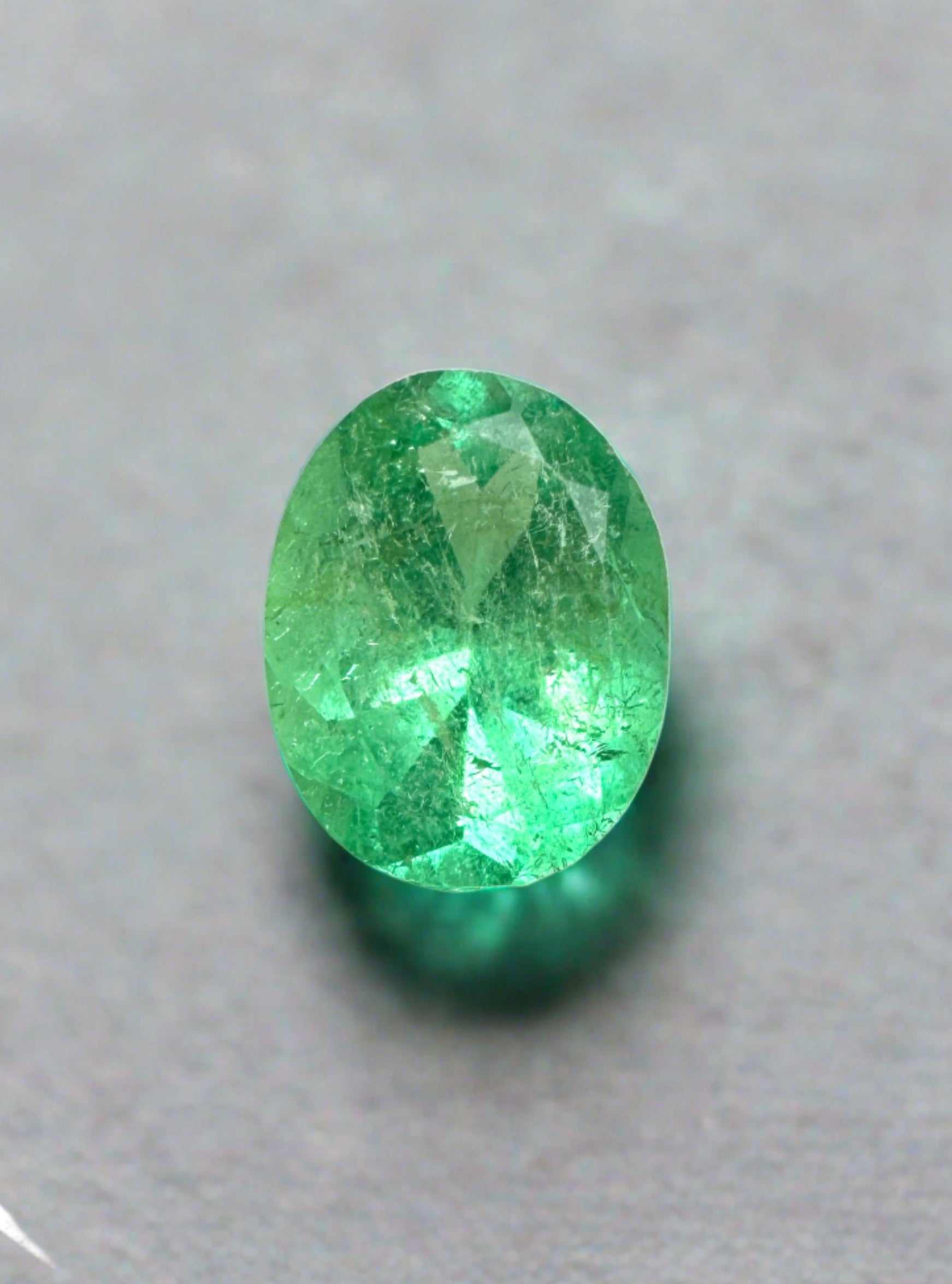 1.19 carat bright yellowish green oval cut natural Colombian emerald gemstone