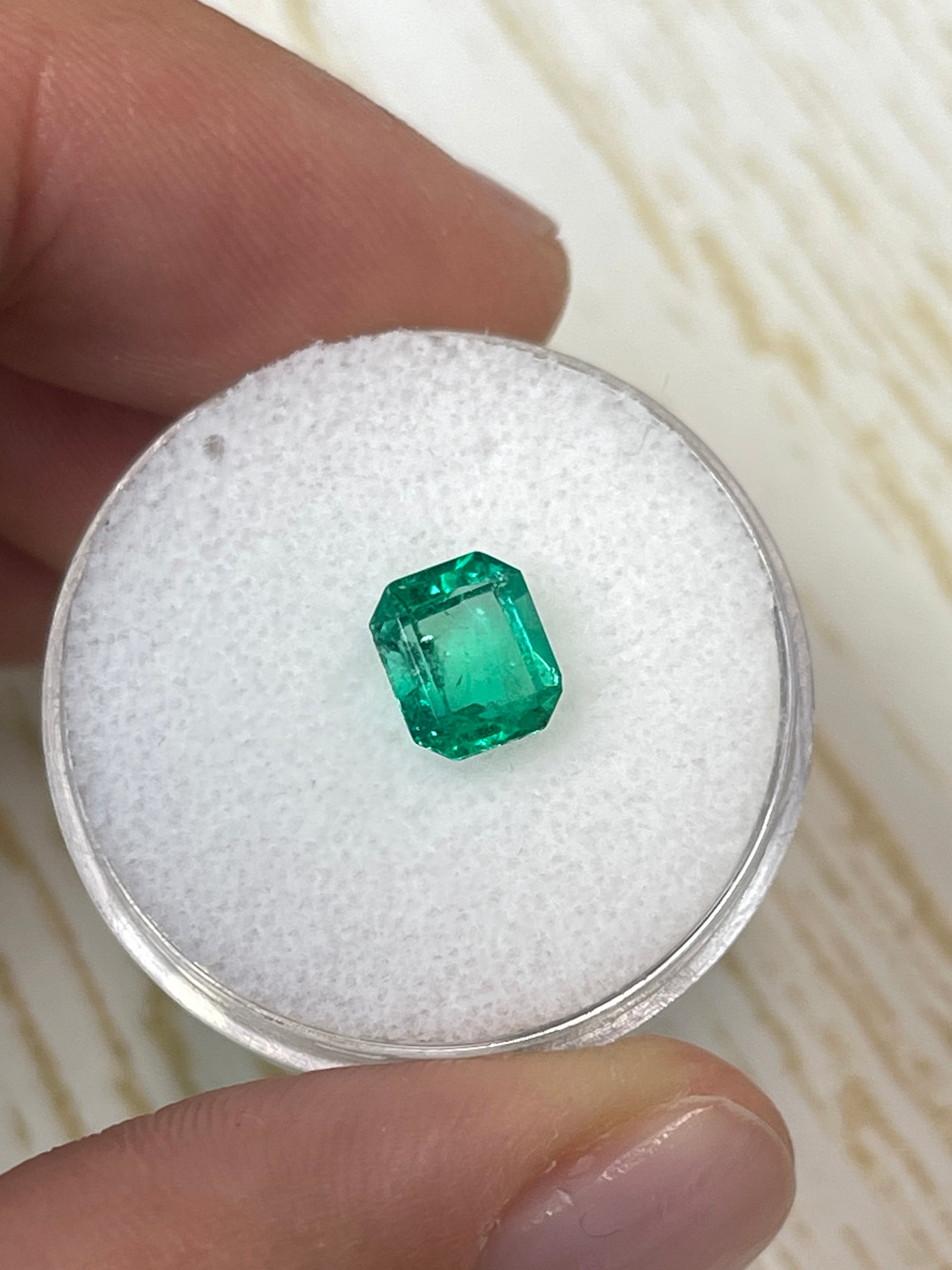 Loose 1.20 carat yellowish green Colombian emerald in an emerald cut, natural gemstone from JR Colombian Emeralds.