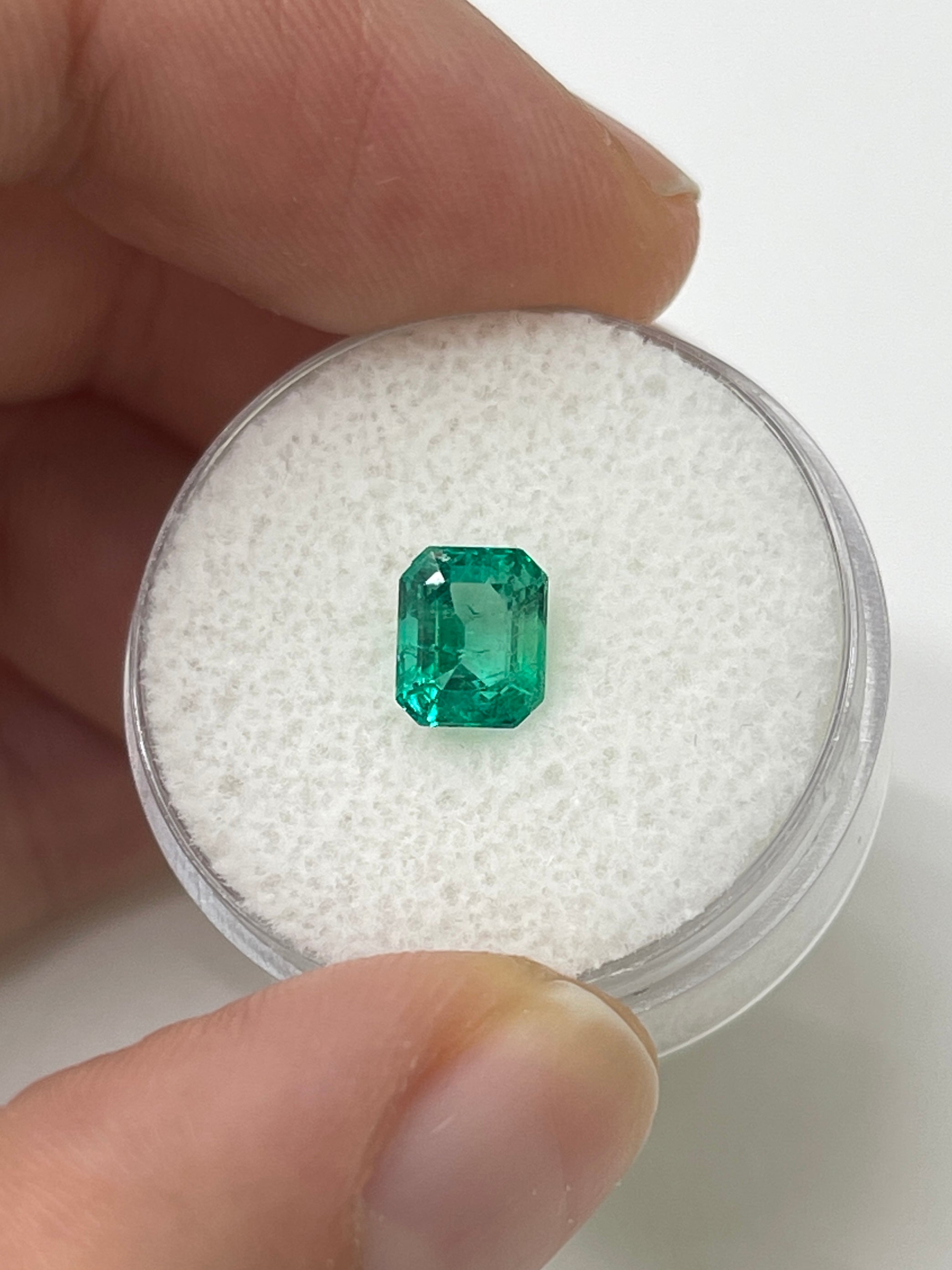 1.22 Carat bluish green natural Colombian emerald loose gemstone in an emerald cut, showcased by JR Colombian Emeralds.