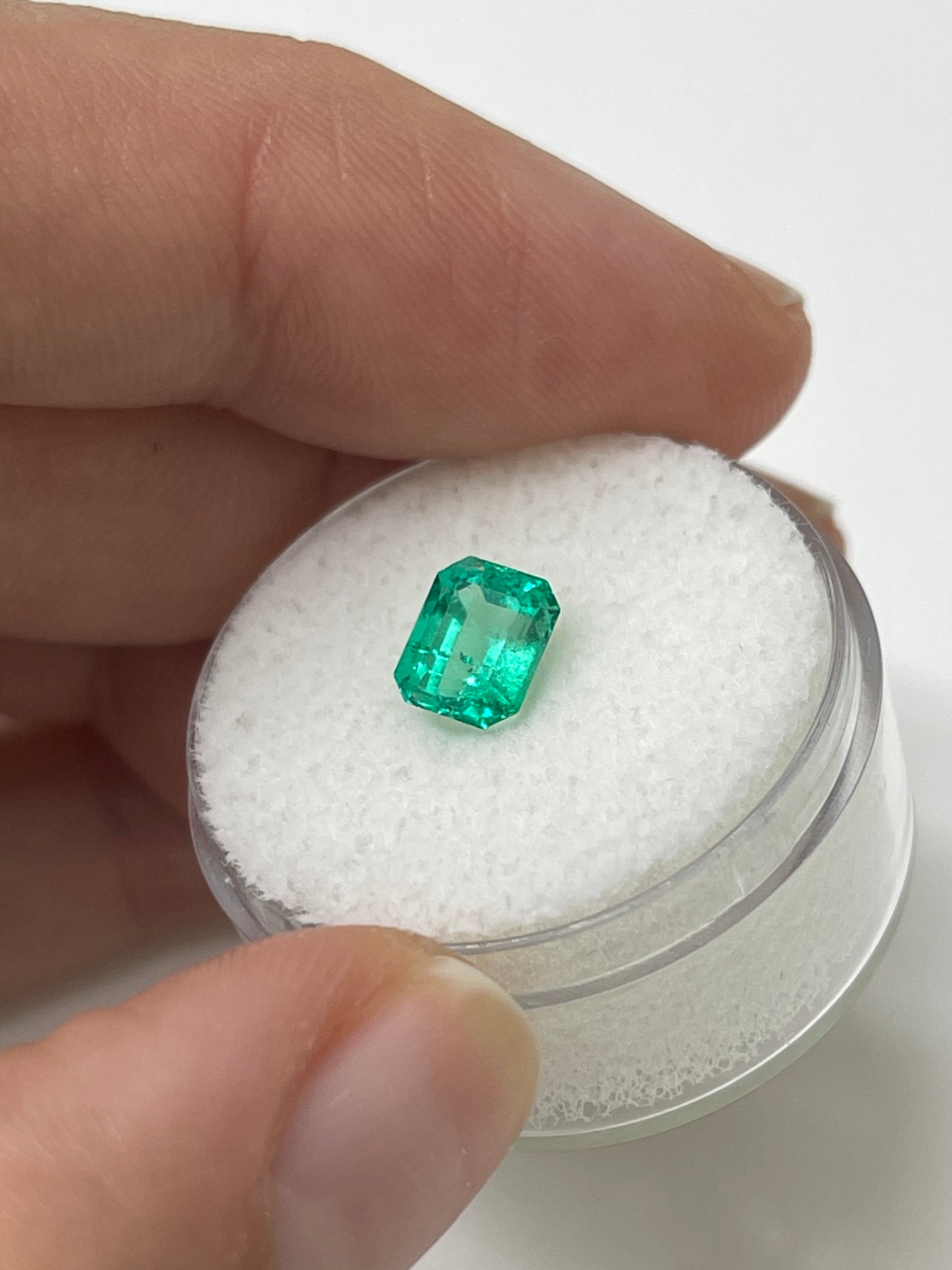 1.22 carat bluish green natural Colombian emerald loose gemstone in an emerald cut, showcasing vibrant color and clarity.