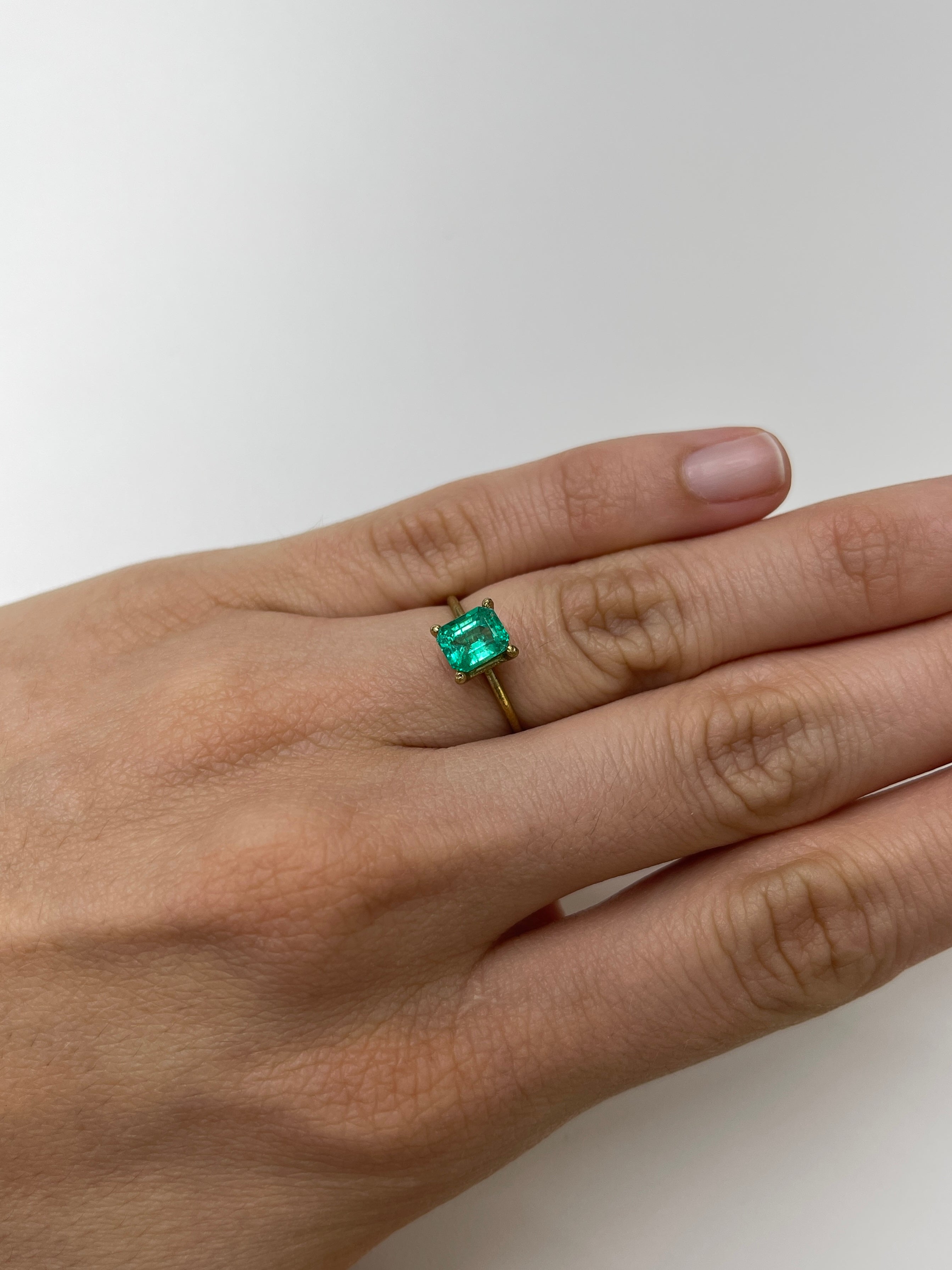Bluish green 1.22 carat natural Colombian emerald in an emerald cut, displayed as a loose gemstone by JR Colombian Emeralds