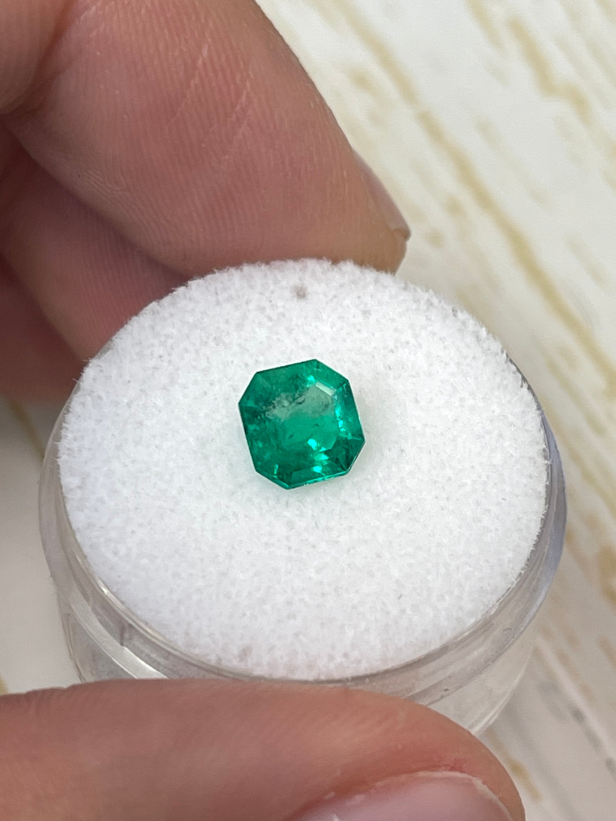 Bluish green 1.24 carat Asscher cut Colombian emerald by JR Colombian Emeralds, natural uncut gemstone with rectangular facets.