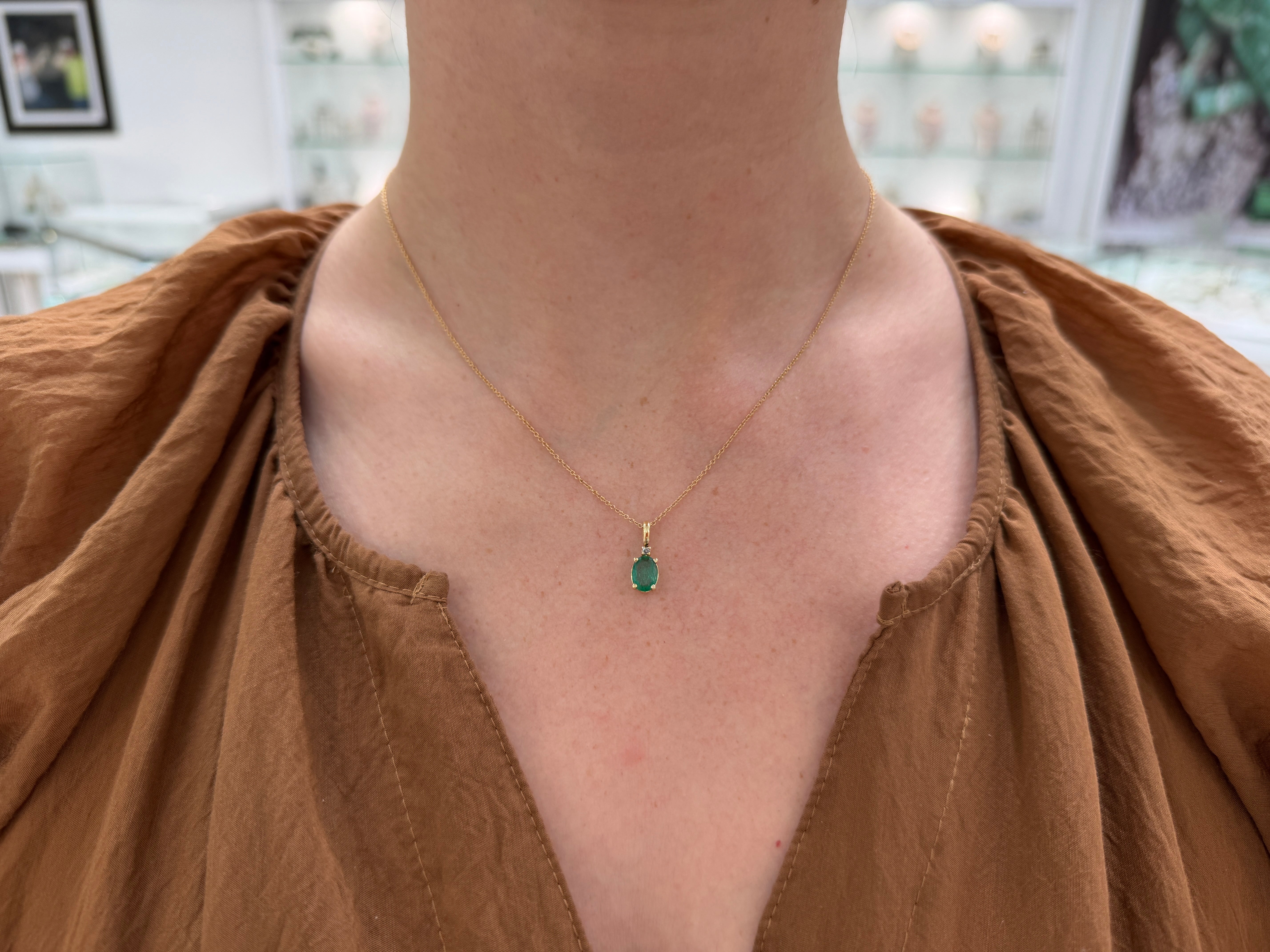 14K yellow gold pendant necklace featuring a 1.30tcw oval cut natural emerald with diamond accents from JR Colombian Emeralds.