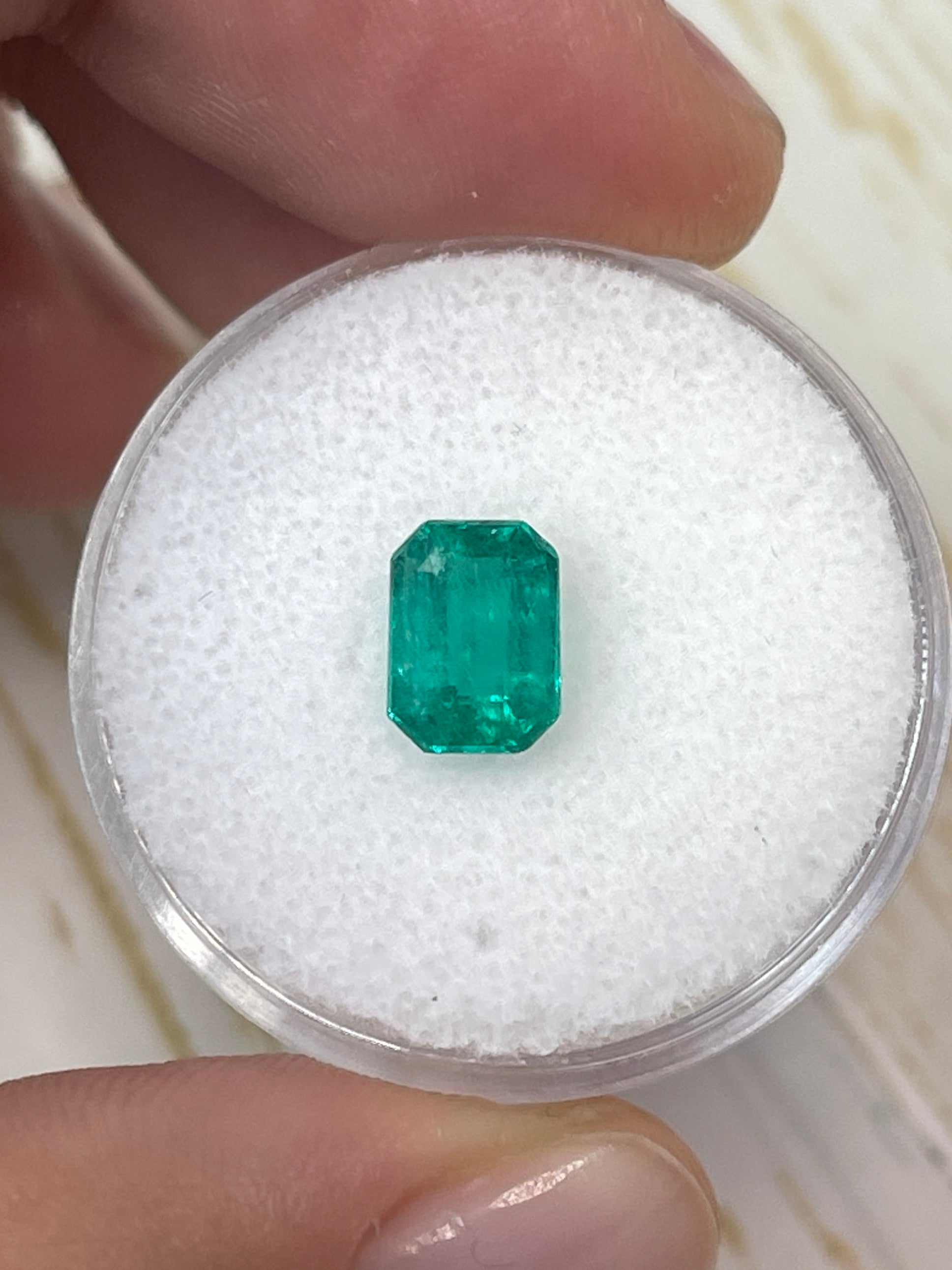 Loose 1.31 carat Colombian emerald in an emerald cut, showcasing vibrant green color and clarity, by JR Colombian Emeralds.