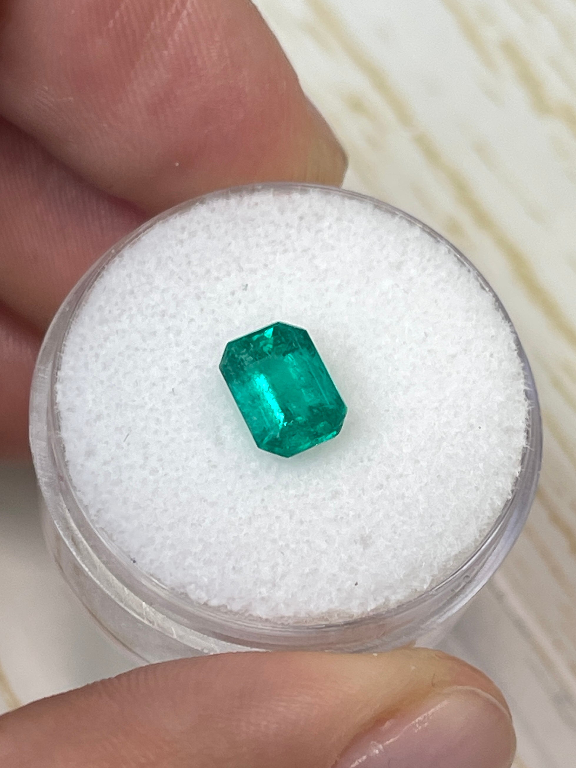 Loose 1.31 Carat Colombian Emerald in an 8x6 emerald cut, showcasing vibrant green color and clarity, from JR Colombian Emeralds.