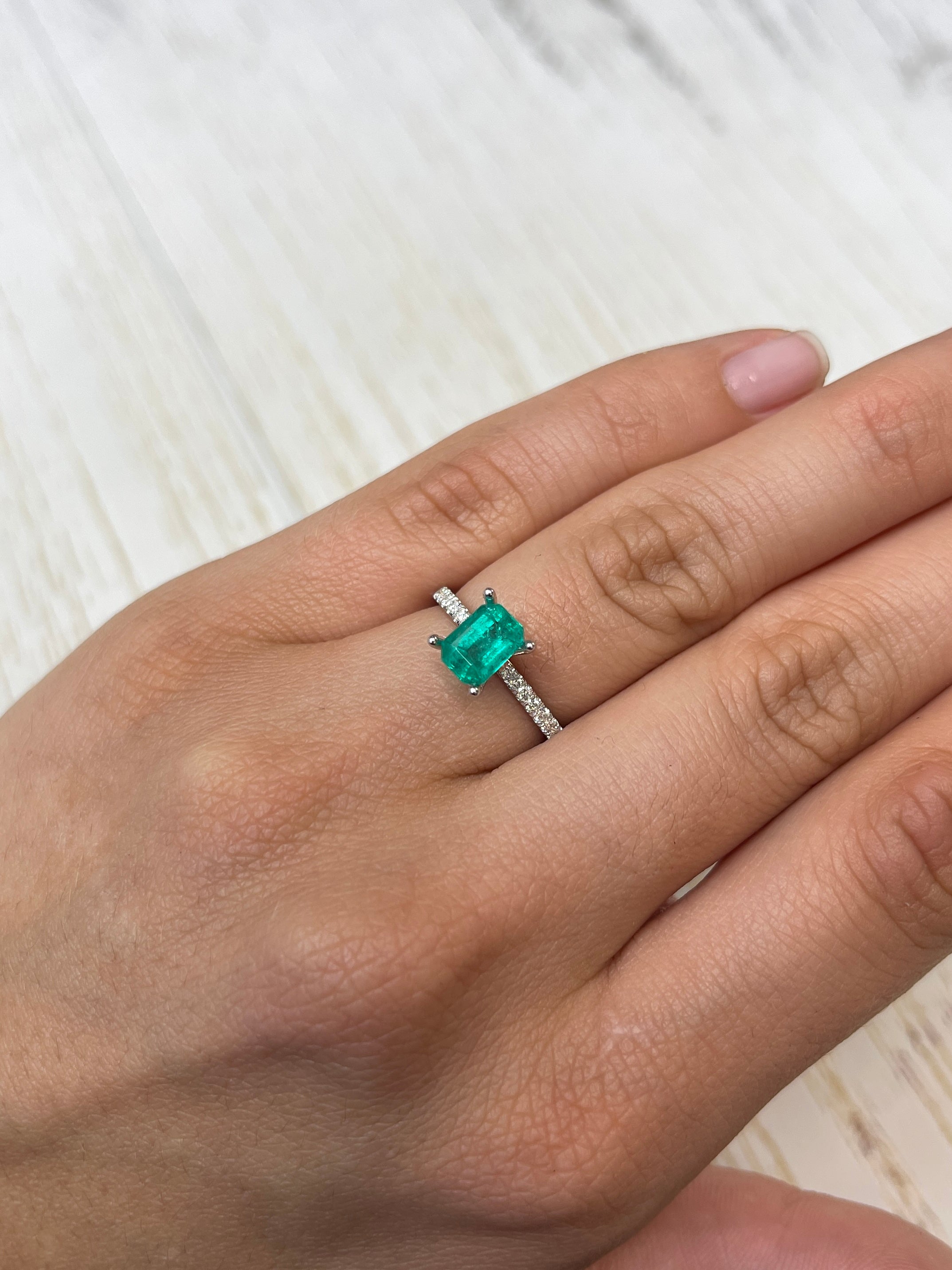 Loose 1.31 carat Colombian emerald in an 8x6 emerald cut, showcased by JR Colombian Emeralds.