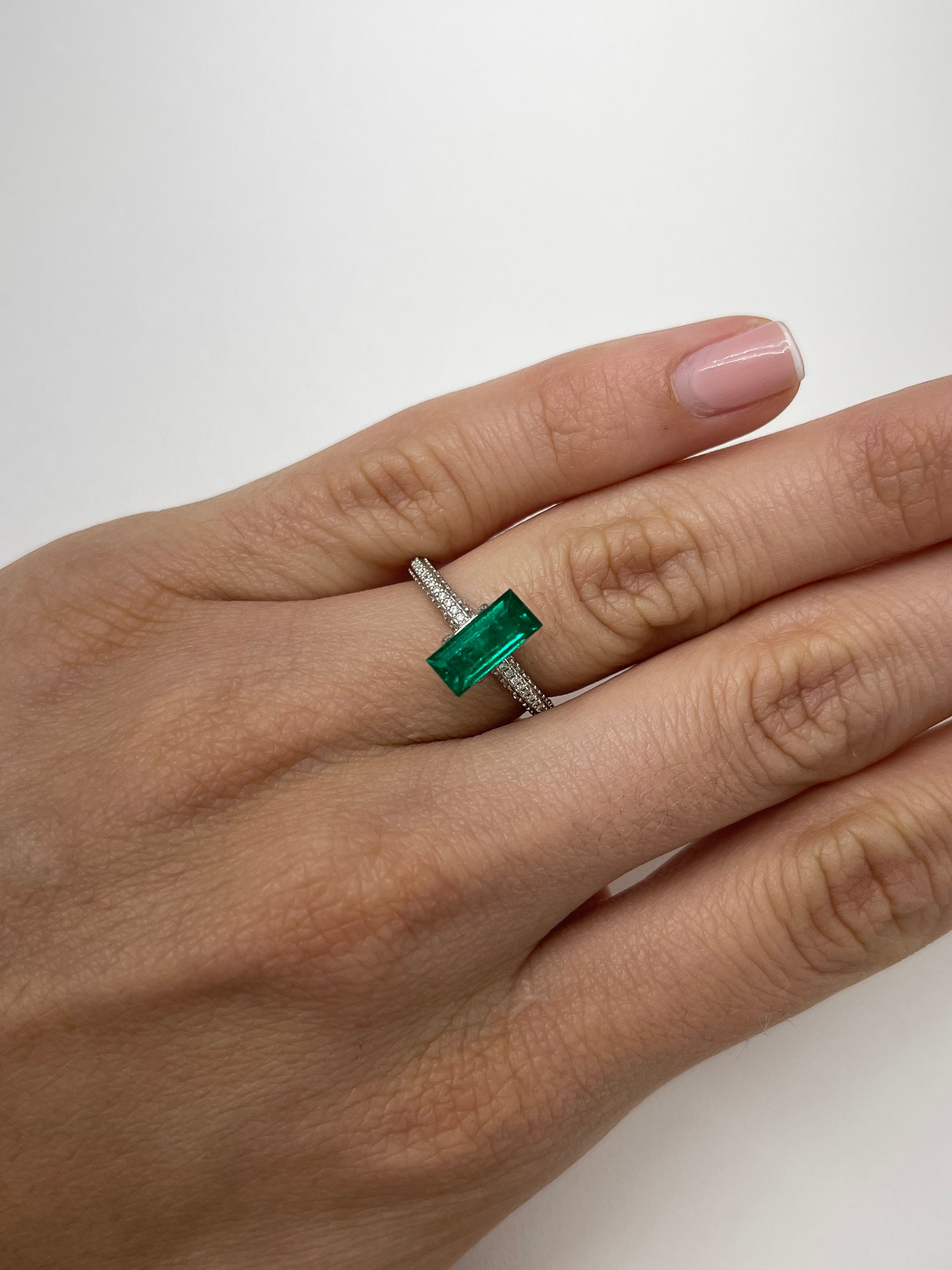 1.38 carat AAA+ Muzo Colombian emerald loose baguette gemstone from JR Colombian Emeralds, showcasing vibrant green color and rectangular cut.