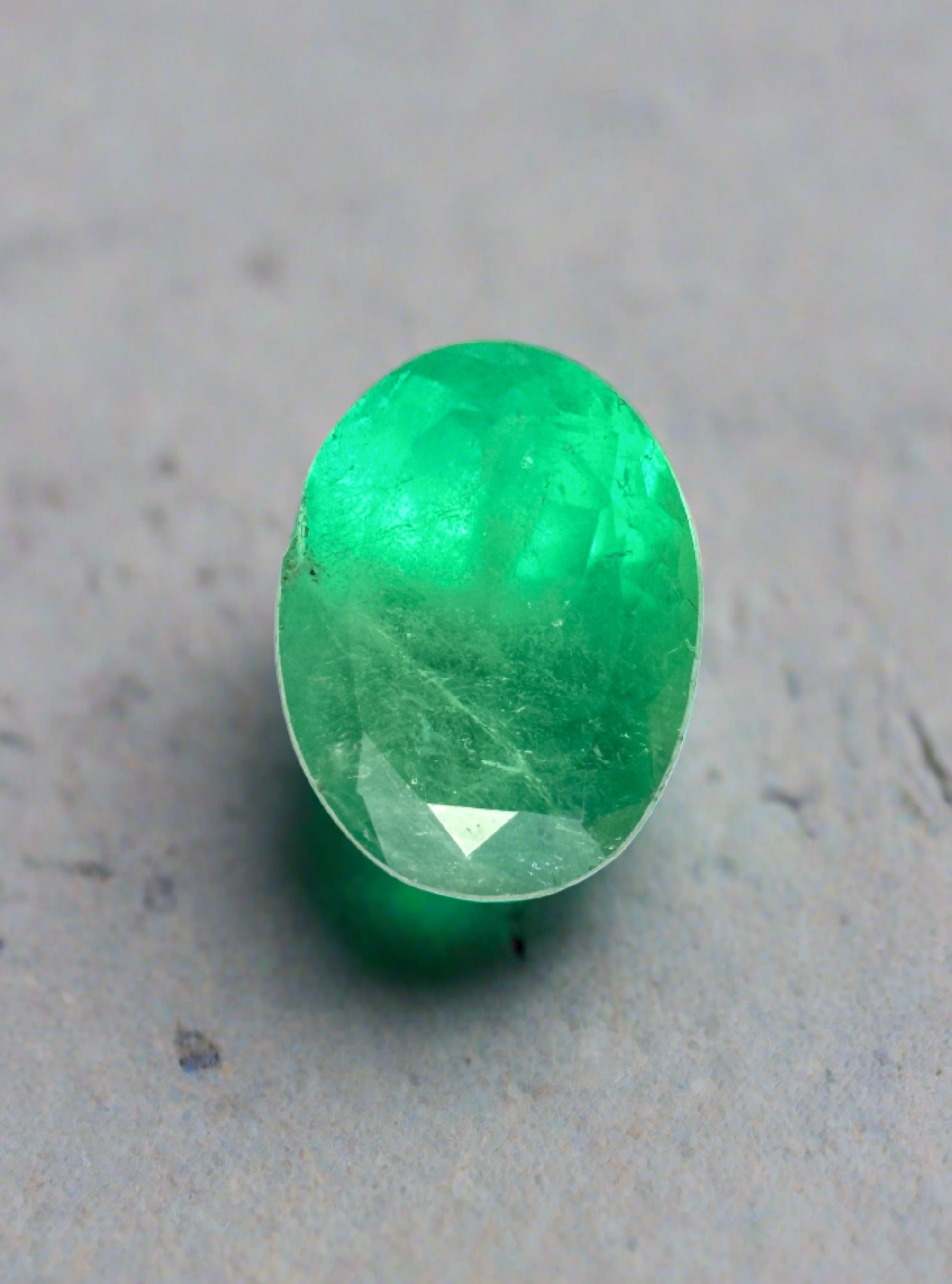 Oval cut 1.40 carat bright apple green natural Colombian emerald loose gemstone by JR Colombian Emeralds.