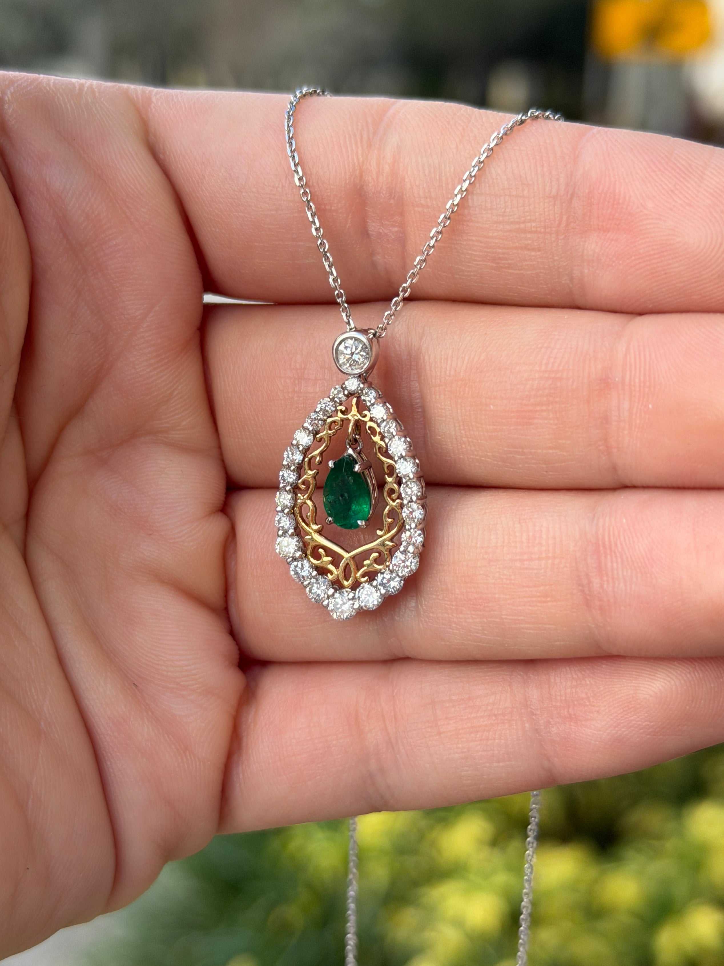 Pear emerald and diamond statement necklace by JR Colombian Emeralds, 14K two-tone gold with intricate design details.