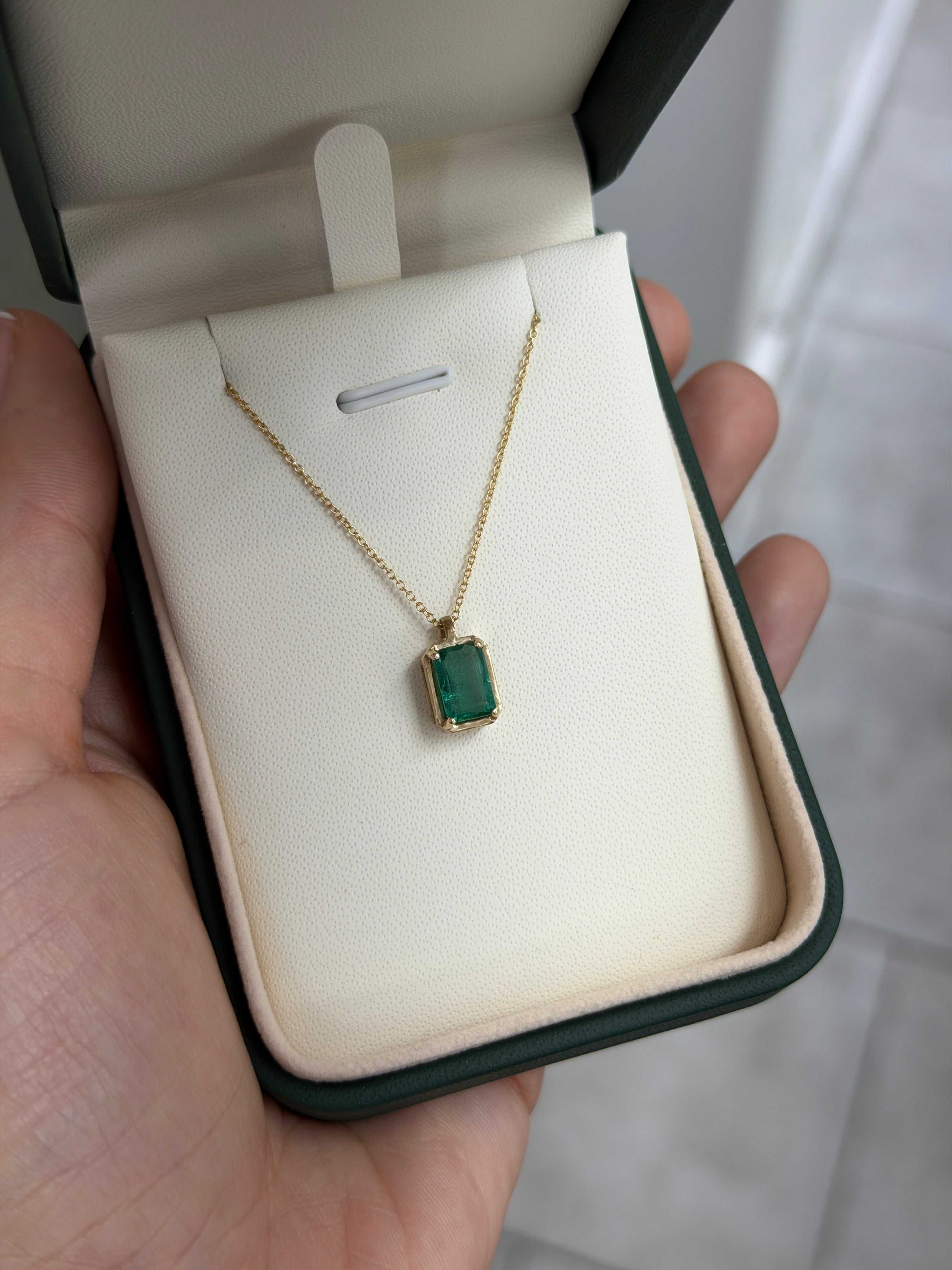 1.59 carat bluish green emerald solitaire necklace with 14K gold chain, featuring a crystal clear emerald pendant from JR Colombian Emeralds.