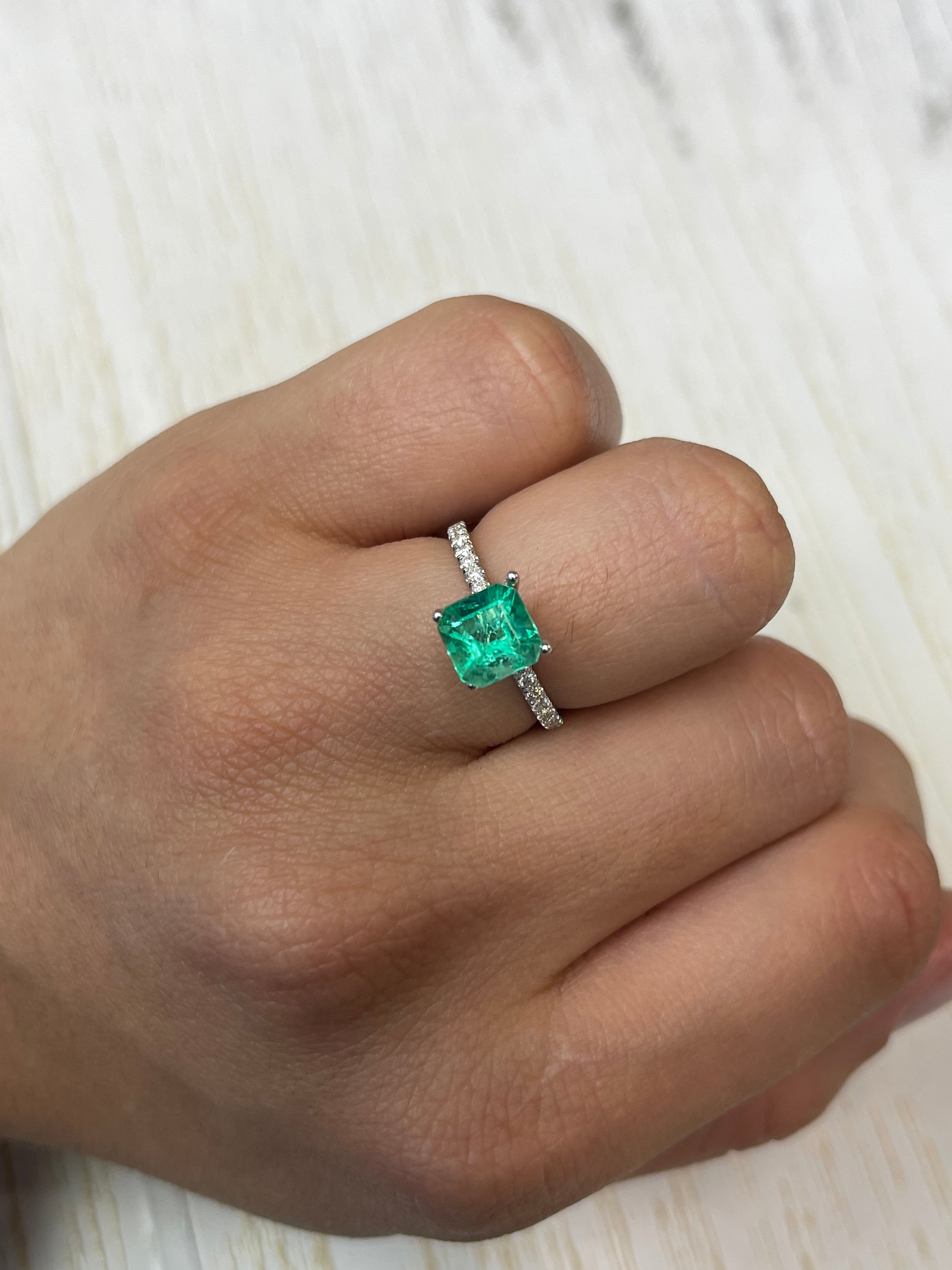 1.64 carat yellowish green Asscher cut Colombian emerald from JR Colombian Emeralds, natural unset gemstone with precise facets.