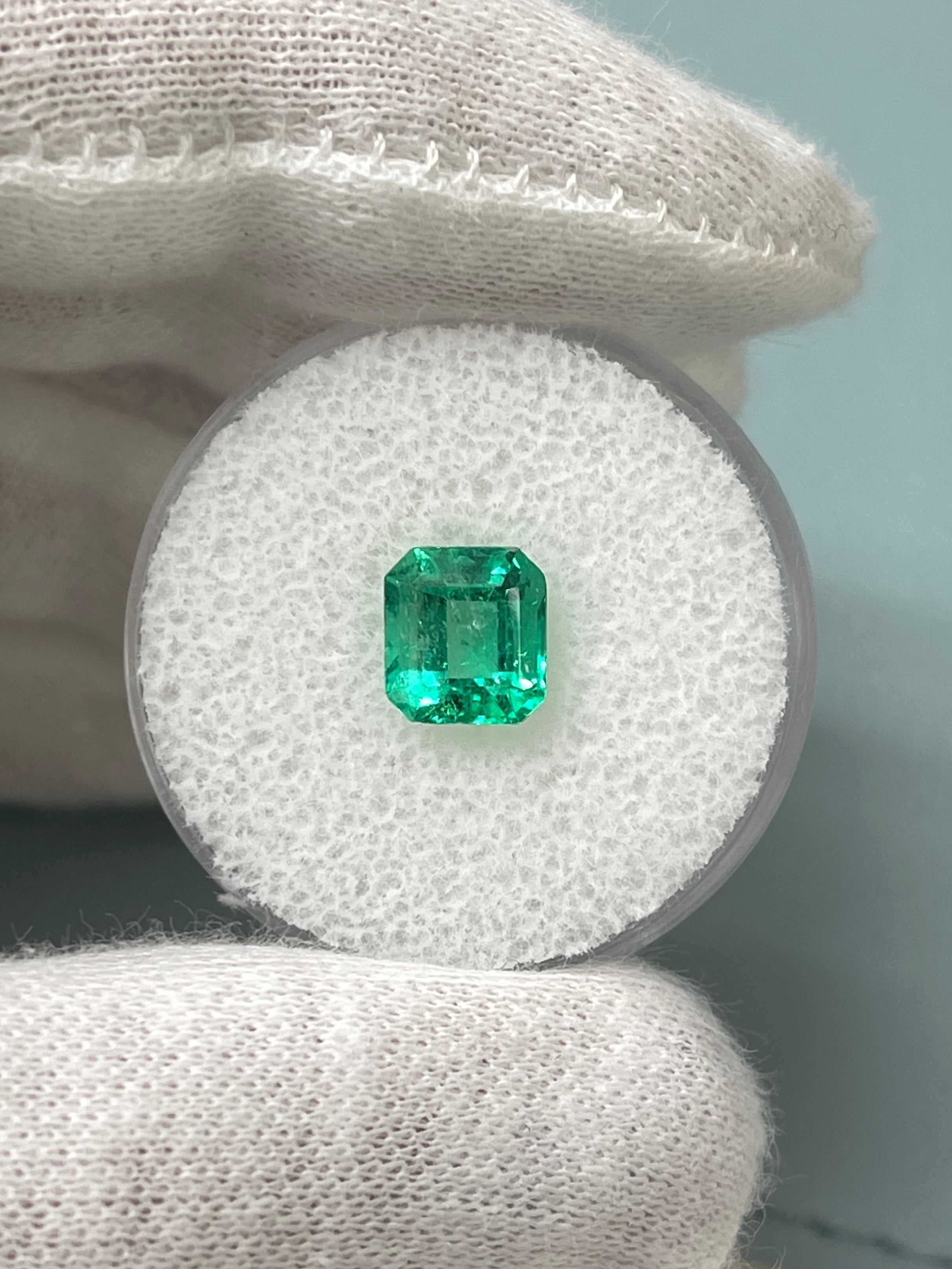 7.5x7 Asscher cut natural Colombian emerald in yellowish green, showcasing its crystalline beauty and rich color.