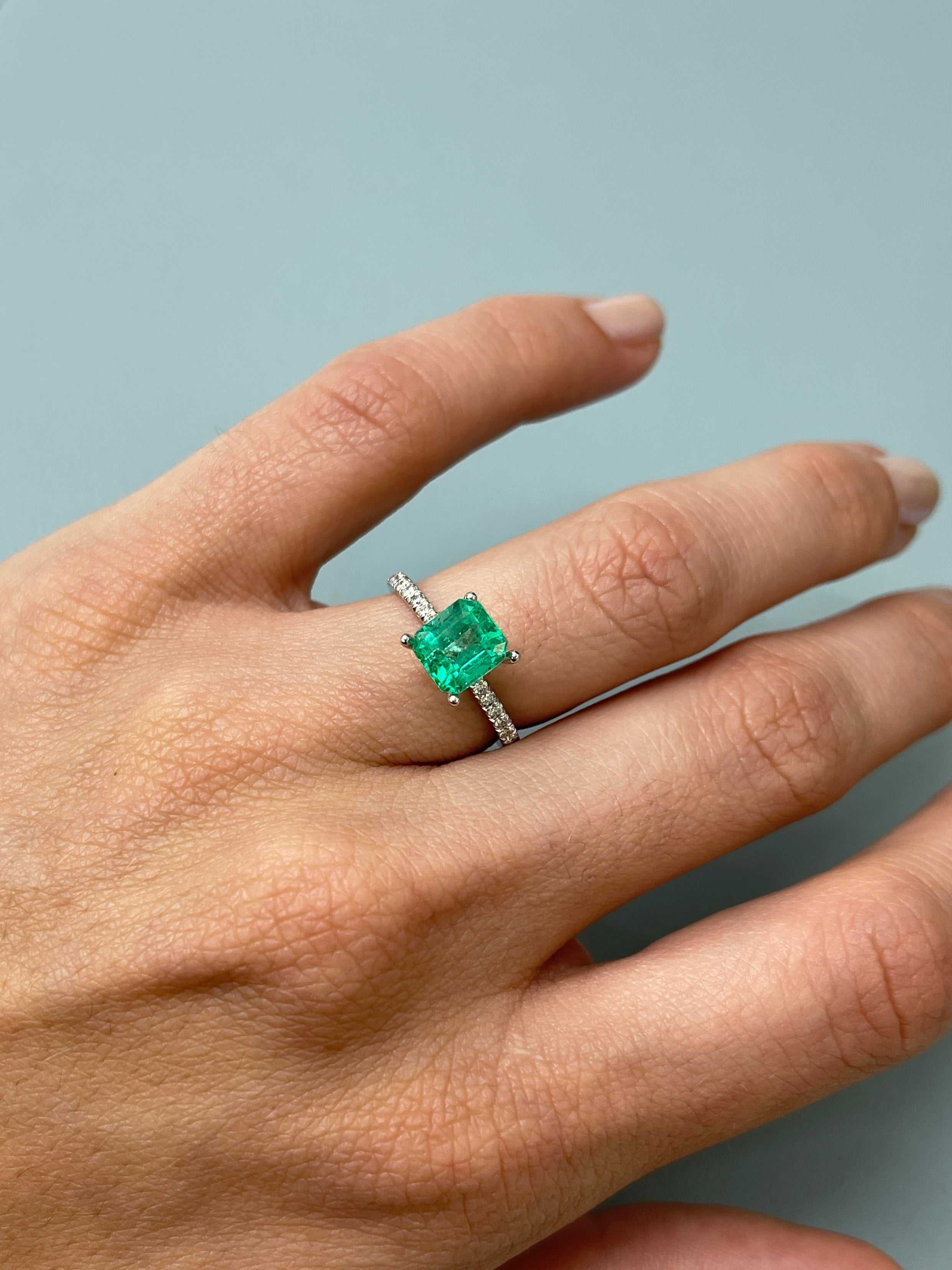 Crystalline Muzo yellowish green Asscher cut natural Colombian emerald, 1.68 carats, 7.5x7 mm, on a neutral background.
