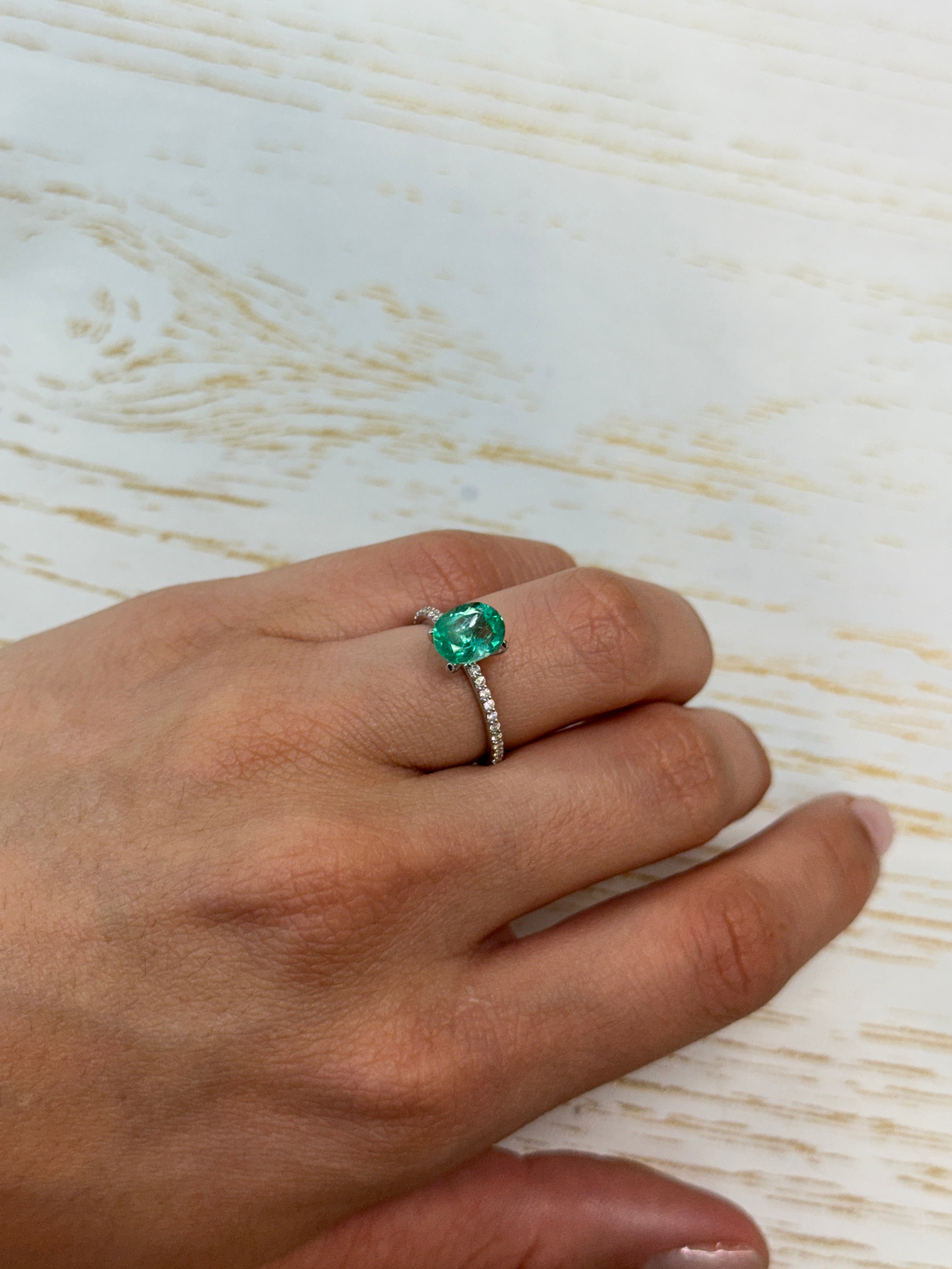 Oval-cut 1.72 carat Colombian emerald with crystalline spring green hue, natural loose gemstone from JR Colombian Emeralds.