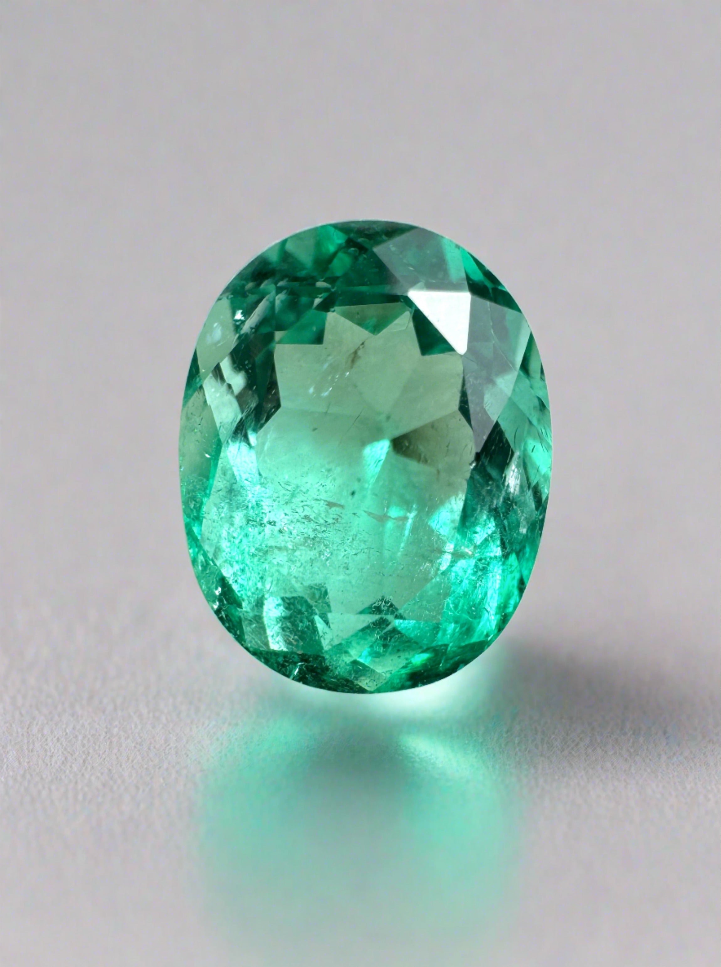Oval-cut 1.72 carat spring green Colombian emerald gemstone with crystalline clarity, natural loose emerald from JR Colombian Emeralds.