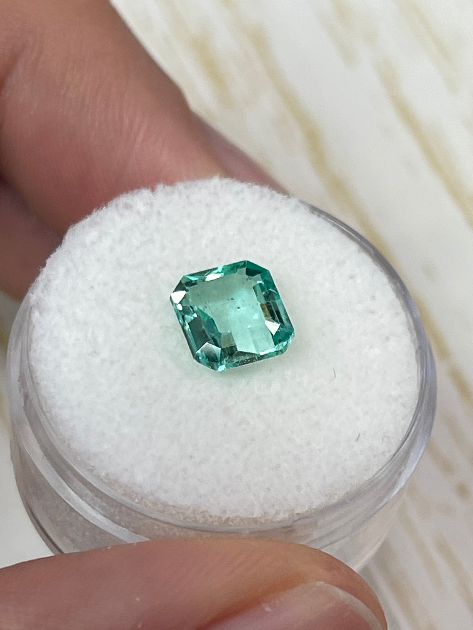 1.74 carat freckled Colombian emerald in Asscher cut, loose gemstone with vibrant green color and unique natural inclusions.