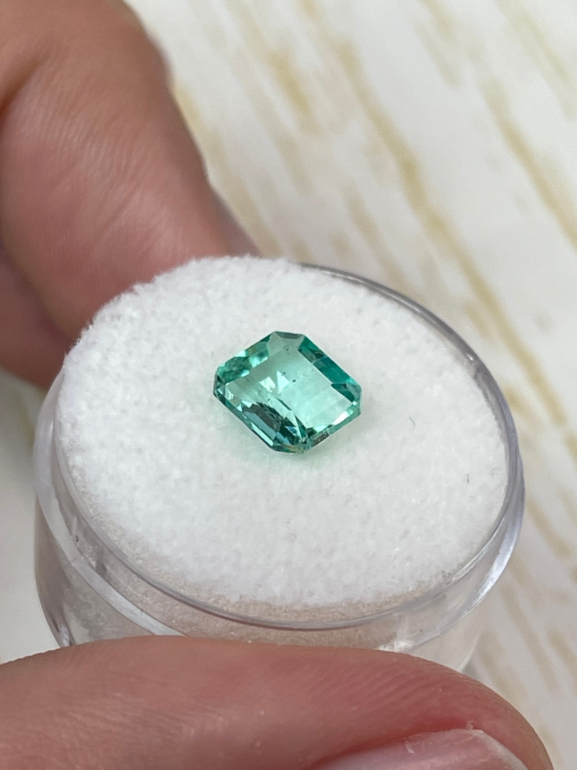 1.74 carat freckled Colombian emerald in Asscher cut, loose gemstone with vibrant green color and distinctive portrait cut from JR Colombian Emeralds.