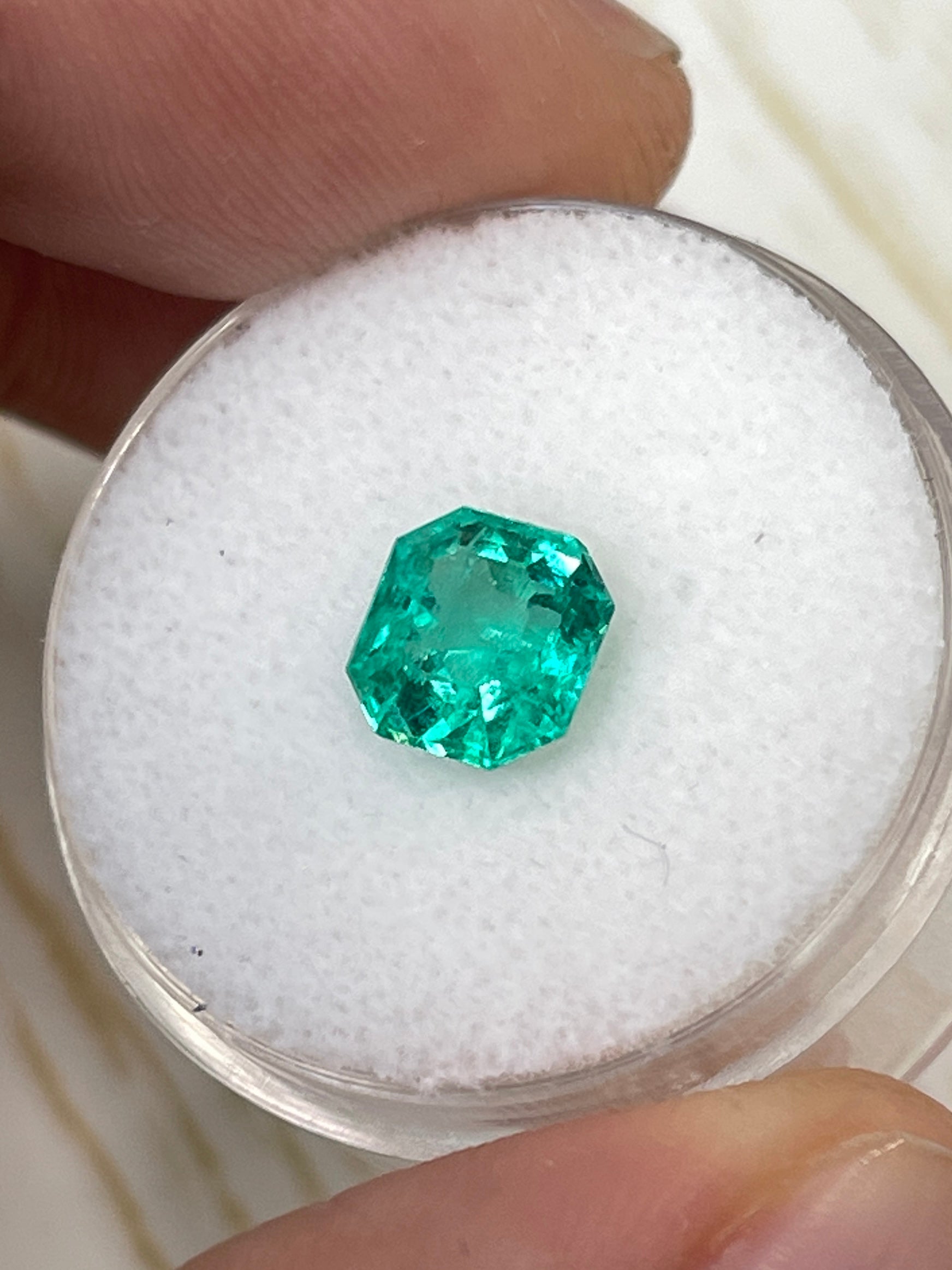 Uncut 1.79 carat crystalline green Colombian emerald with 7.5x7 mm Asscher cut from JR Colombian Emeralds.