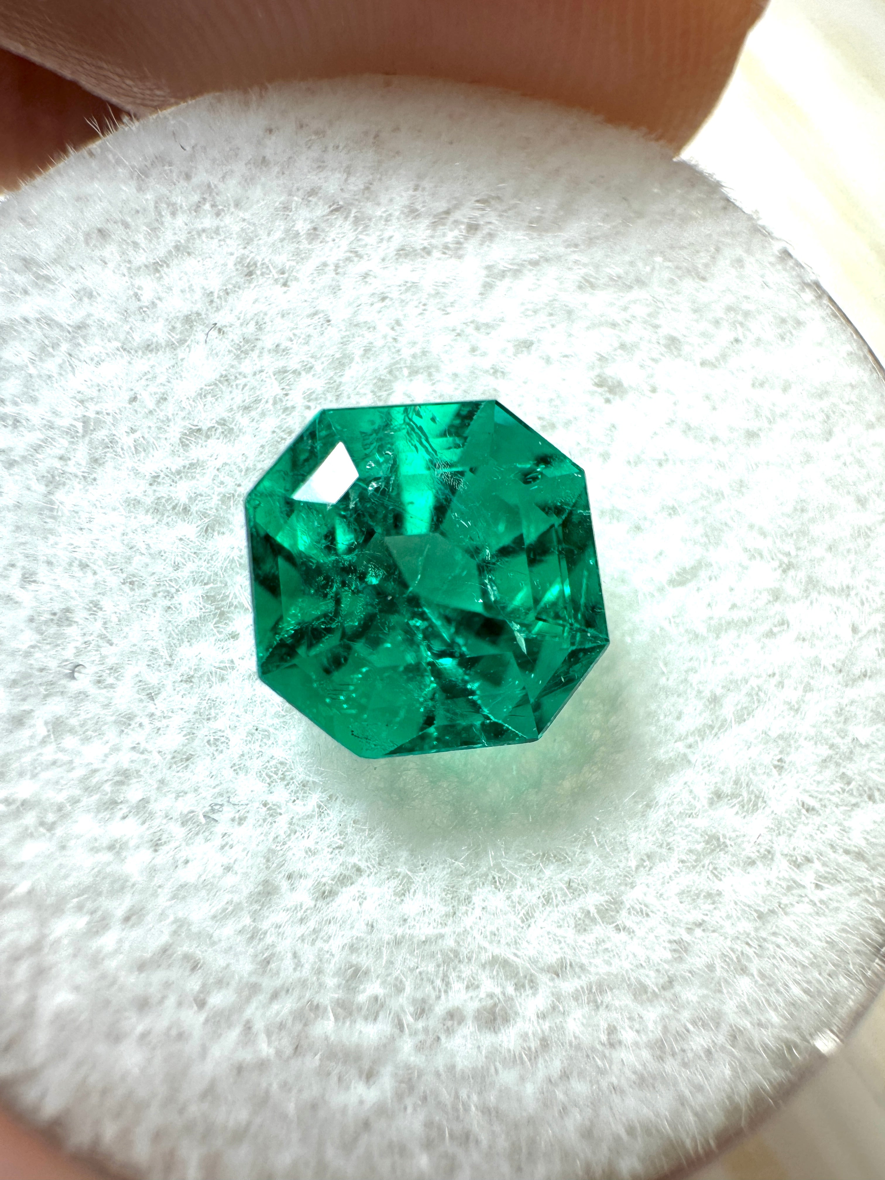 Uncut 1.80 carat AAA+ Muzo Colombian green Asscher cut emerald gemstone from JR Colombian Emeralds, showing deep green color and natural facets.