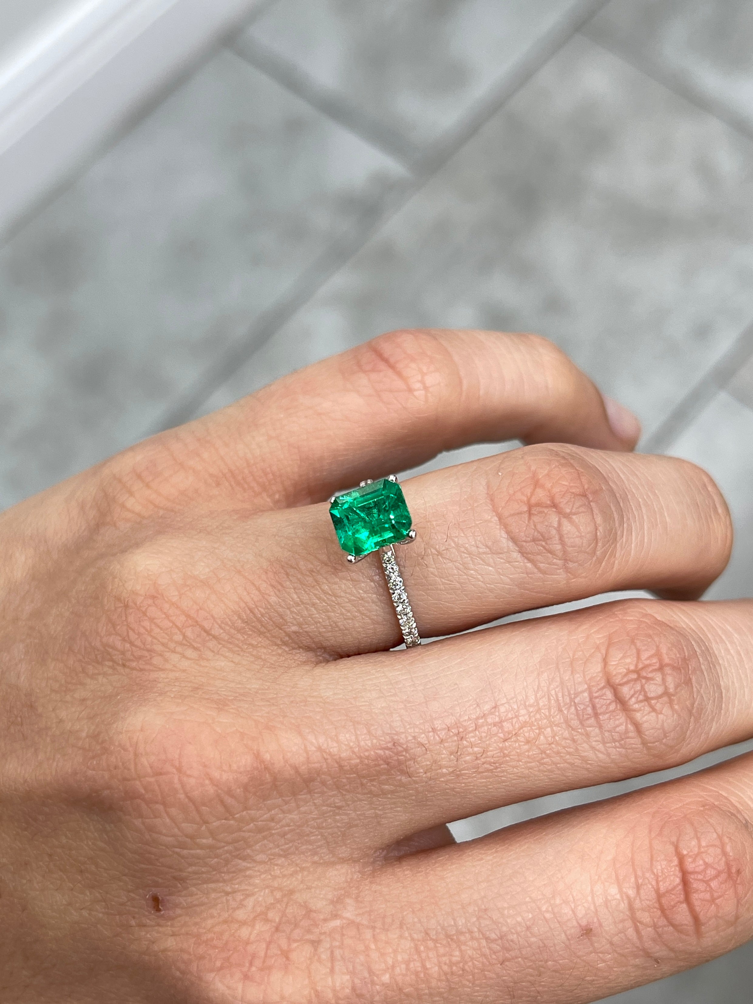 Vivid yellowish green 1.82 carat Colombian emerald cut loose gemstone from JR Colombian Emeralds, showcasing vibrant color and clarity.