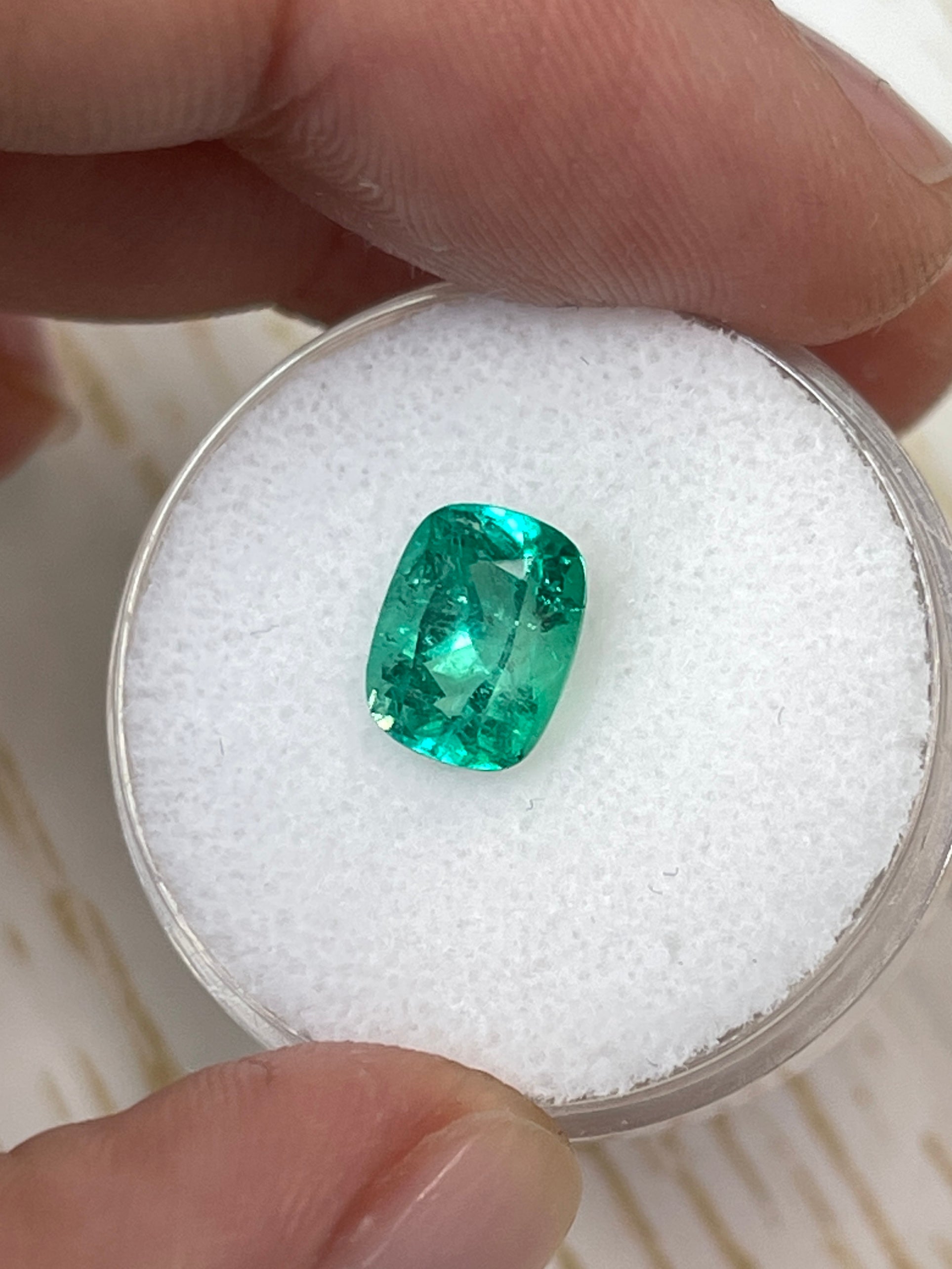 Loose 1.84 carat cushion cut Colombian emerald with bluish green hue, natural and unmounted gemstone from JR Colombian Emeralds.