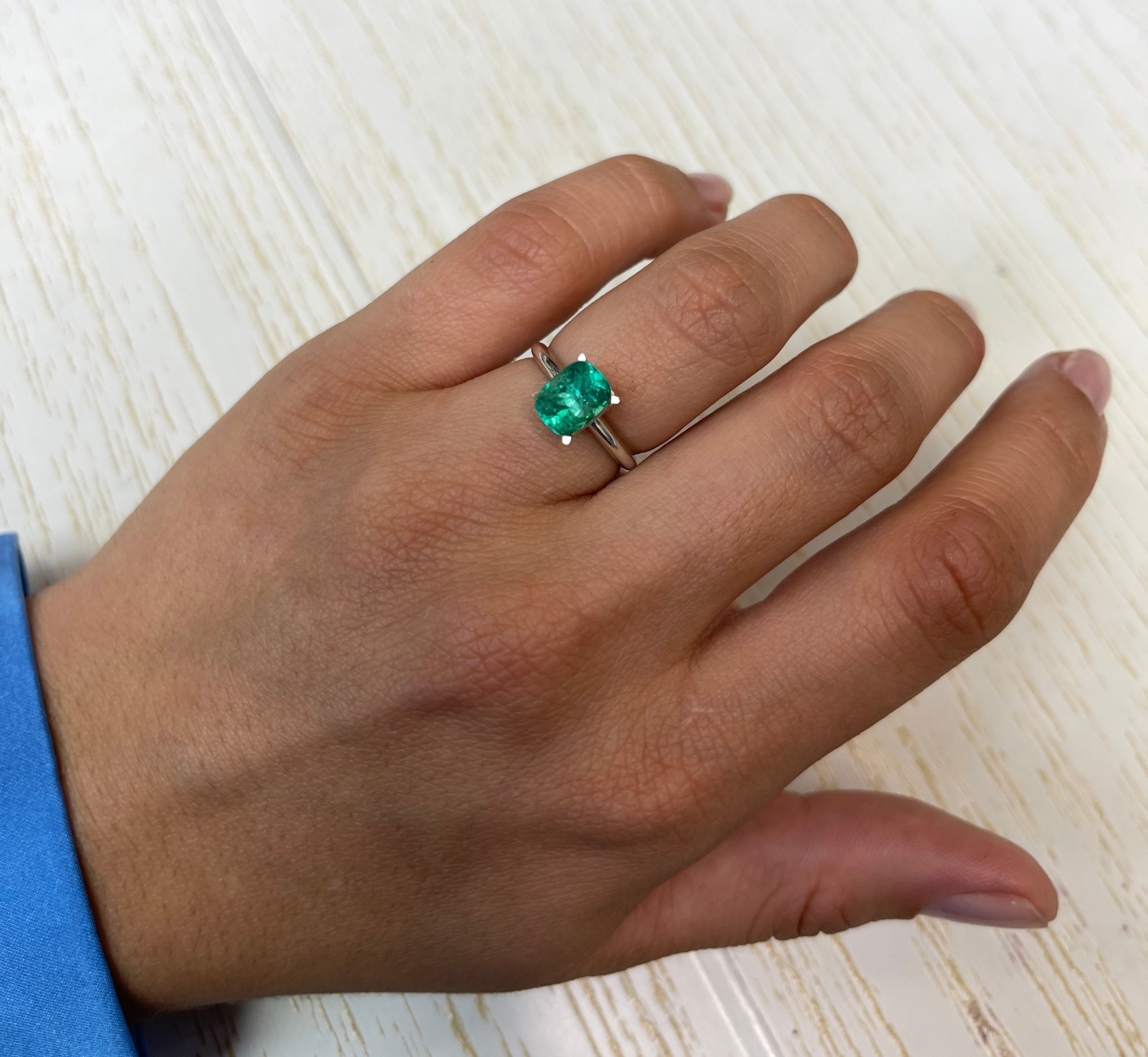 Loose 1.84 carat cushion cut Colombian emerald with bluish green hue, natural gemstone from JR Colombian Emeralds.