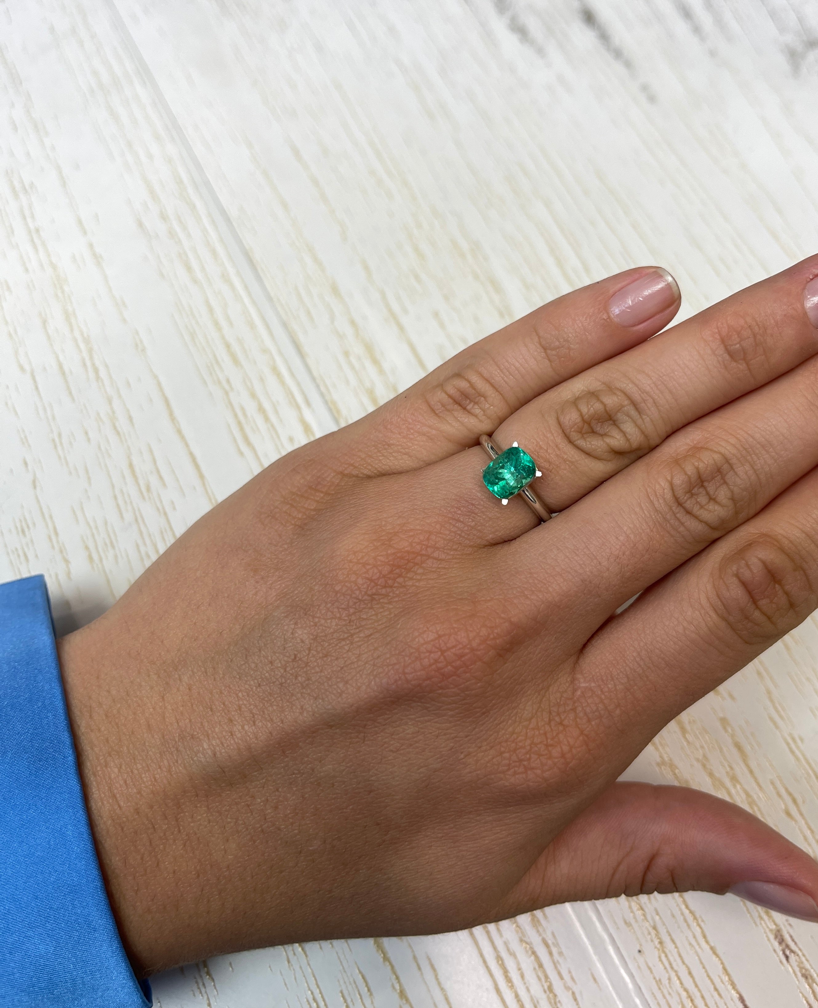 Loose 1.84 carat cushion cut Colombian emerald with bluish green hue, natural gemstone from JR Colombian Emeralds.