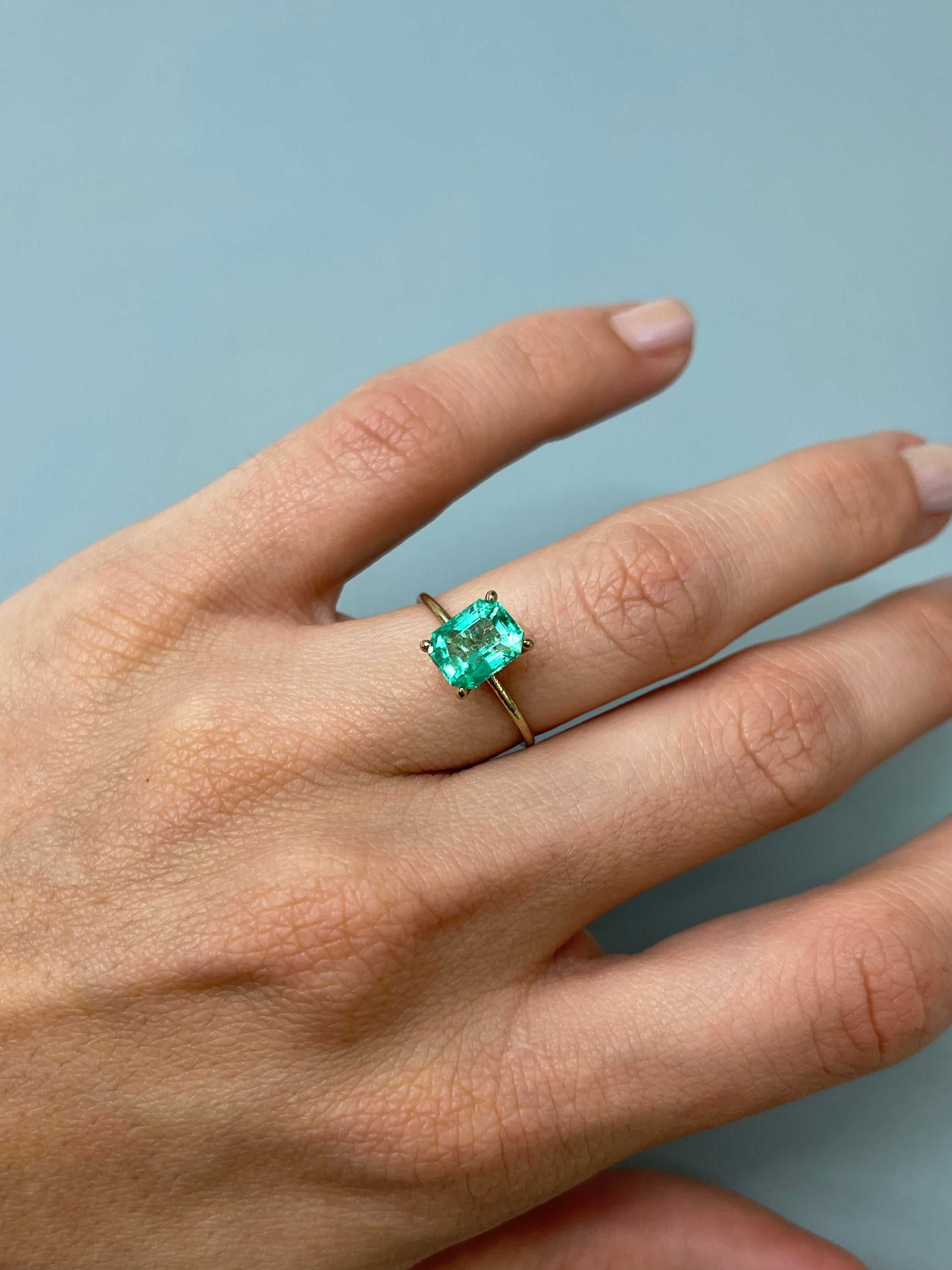 Loose 1.92 carat bluish green Colombian emerald in emerald cut, natural, ultra-glowy, from JR Colombian Emeralds.