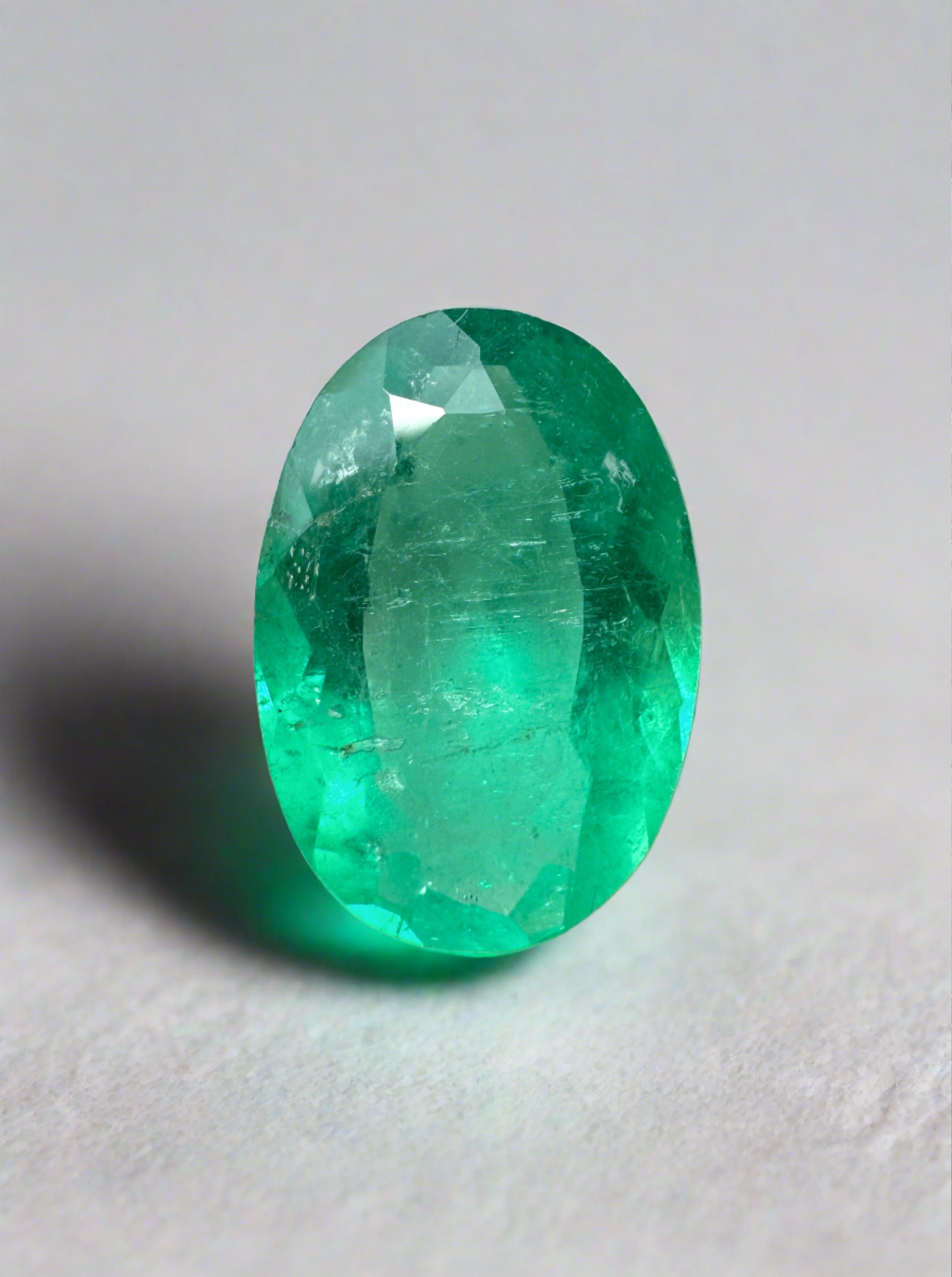 Elongated 11x8mm Apple Green Colombian Emerald loose gemstone, oval cut, 1.96 carats, from JR Colombian Emeralds.