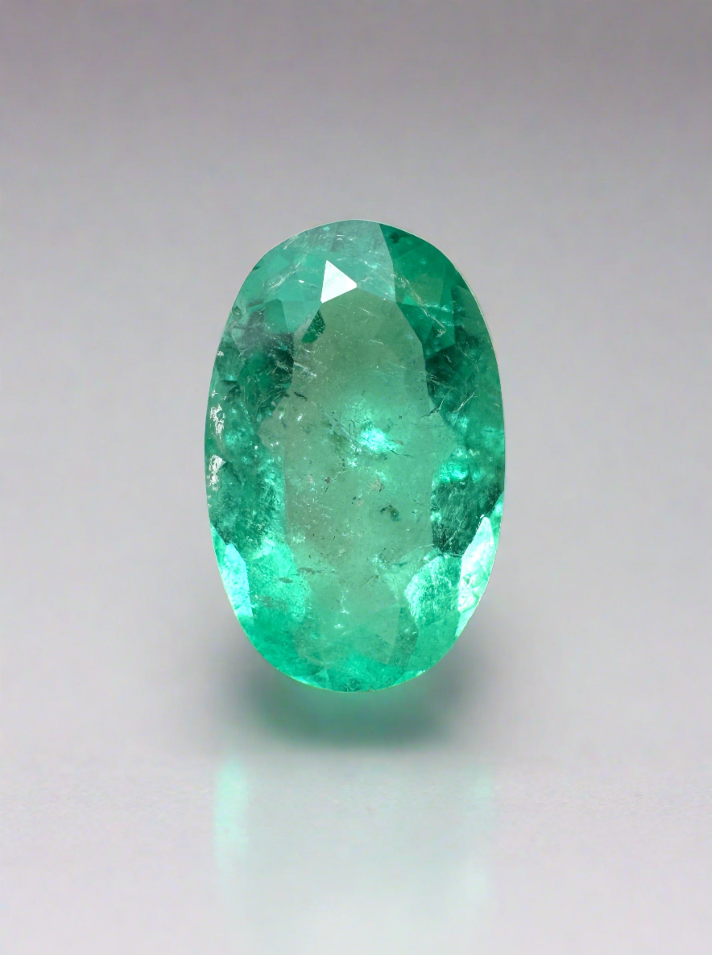 Elongated 11x7mm natural Colombian emerald loose gemstone, 1.98 carats, oval cut with vibrant green color from JR Colombian Emeralds.