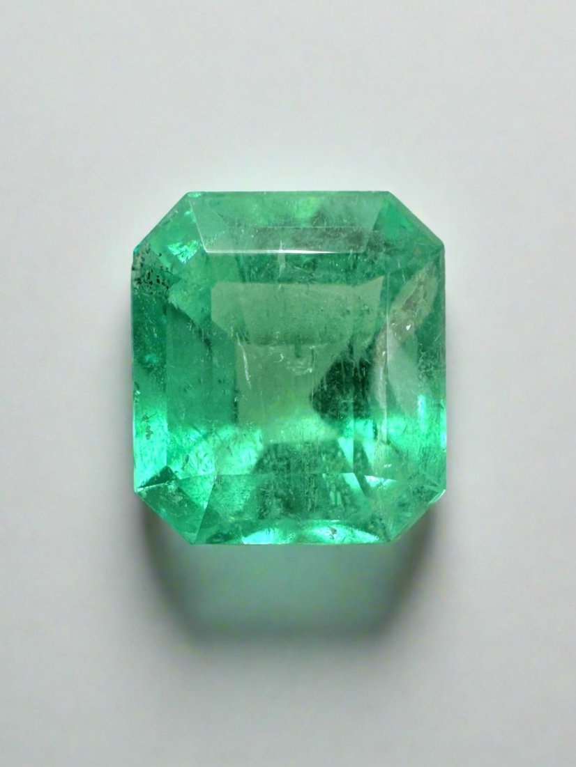 2.08 carat lime yellowish emerald cut natural Colombian emerald gemstone, unset and vibrant with bright green color.