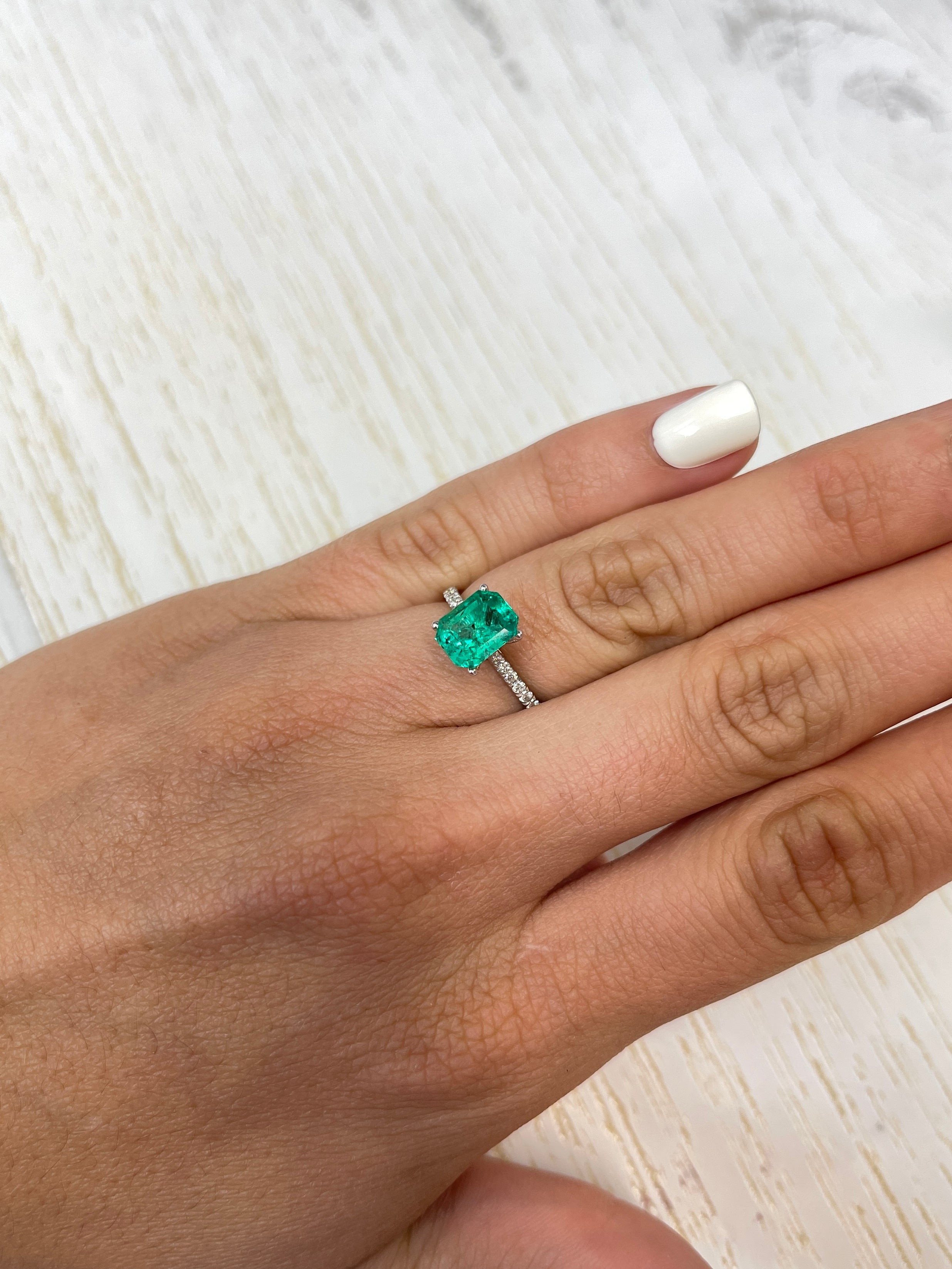 Freckled bluish green 2.12 carat Colombian emerald loose gemstone in an emerald cut, natural and high-quality from JR Colombian Emeralds.